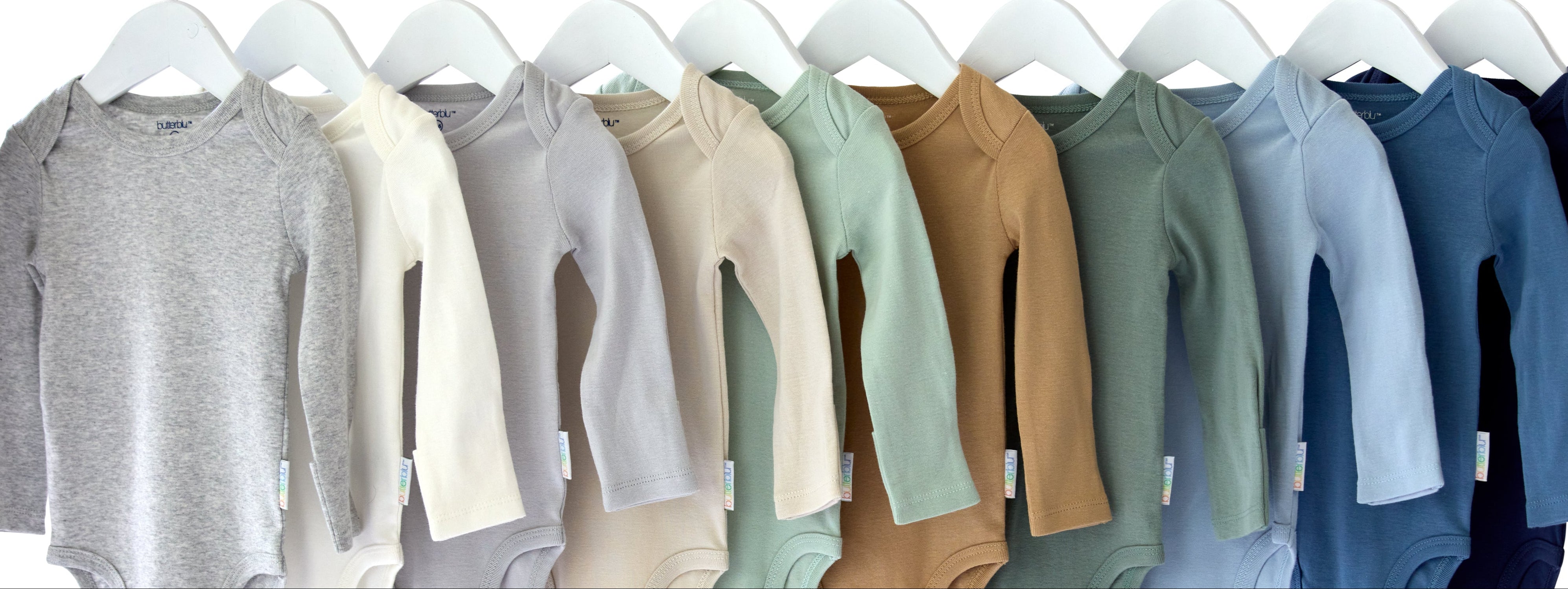 Row of baby onesies in various colors on hangers