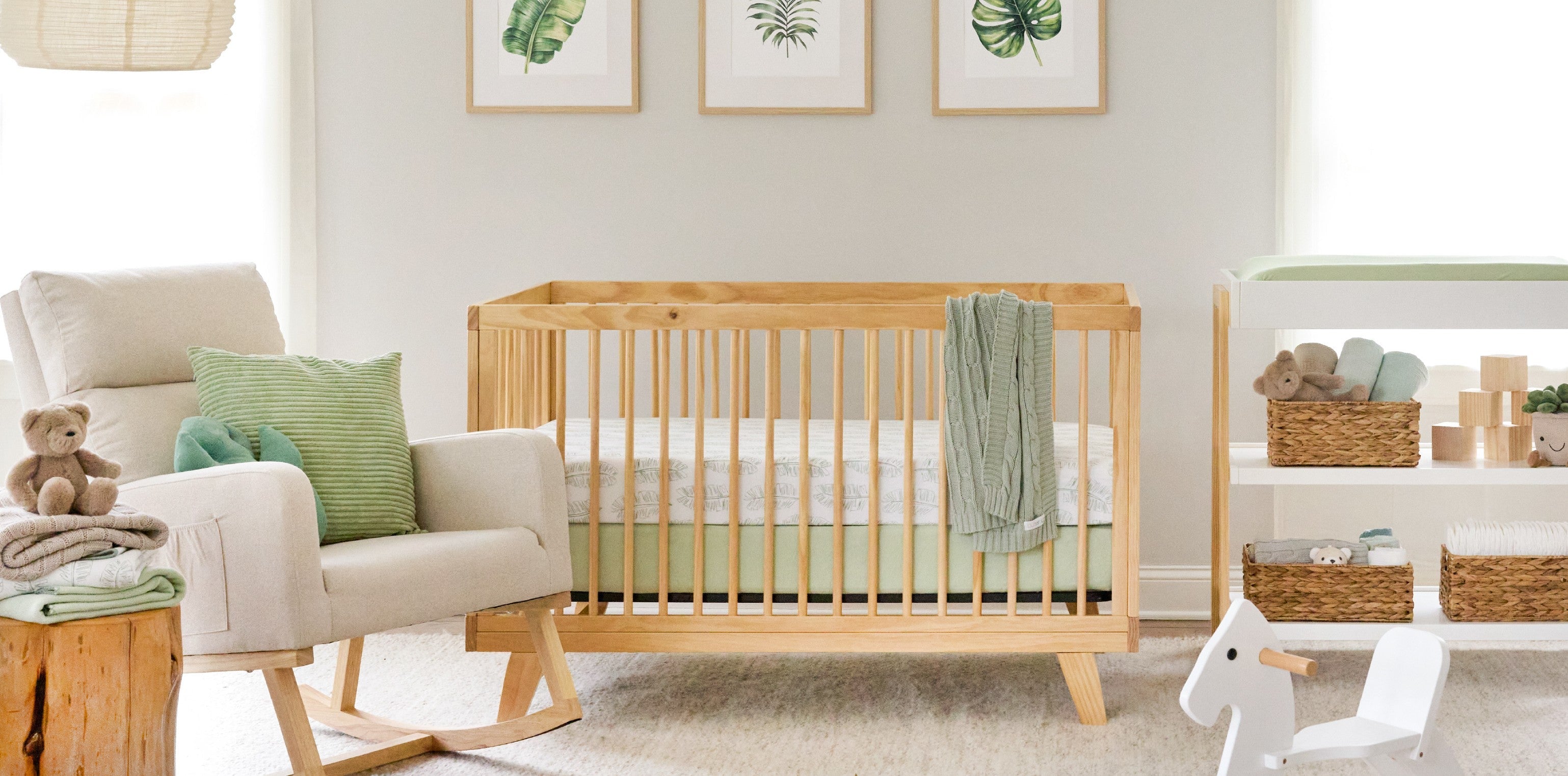 Fern + Feather nursery collection — organic baby bedding, swaddles, and nursery decor in botanical green palette from Butterblu