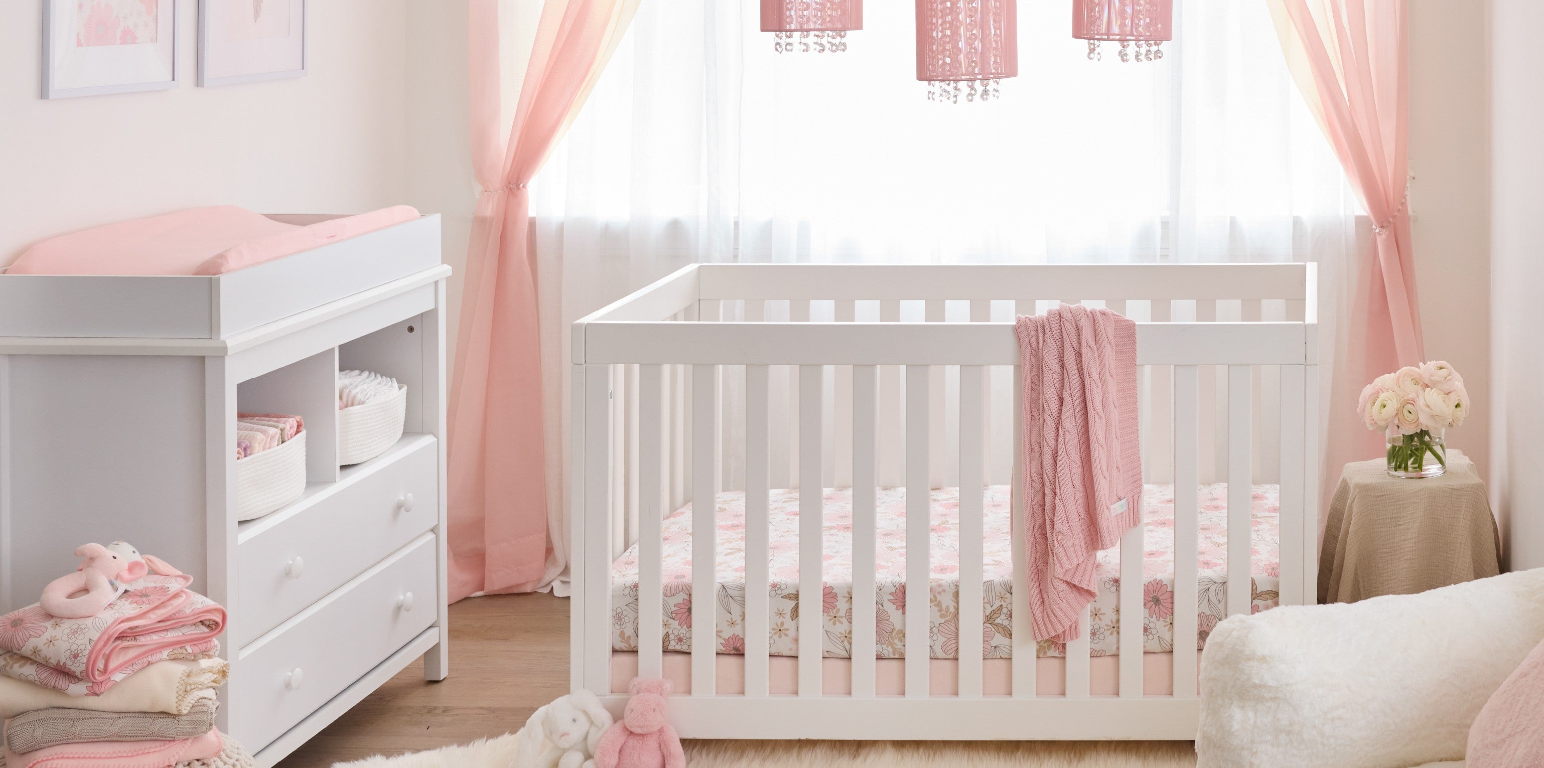 Pretty Petals nursery collection — organic baby bedding, swaddles, and decor in floral pink palette from Butterblu