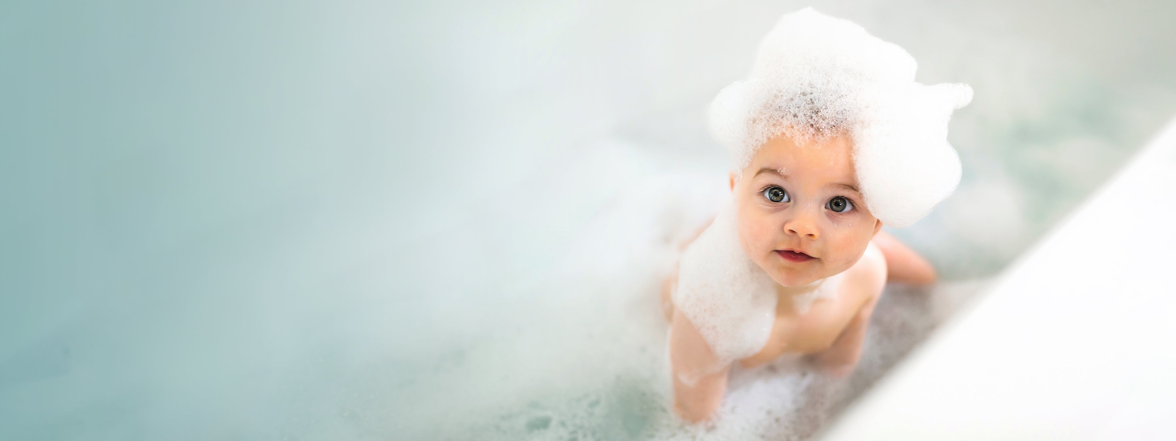 Organic baby bath essentials from Butterblu — GOTS-certified cotton hooded towels, washcloths, and bath sets for newborns