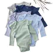 Set of baby bodysuits in various colors on a white background