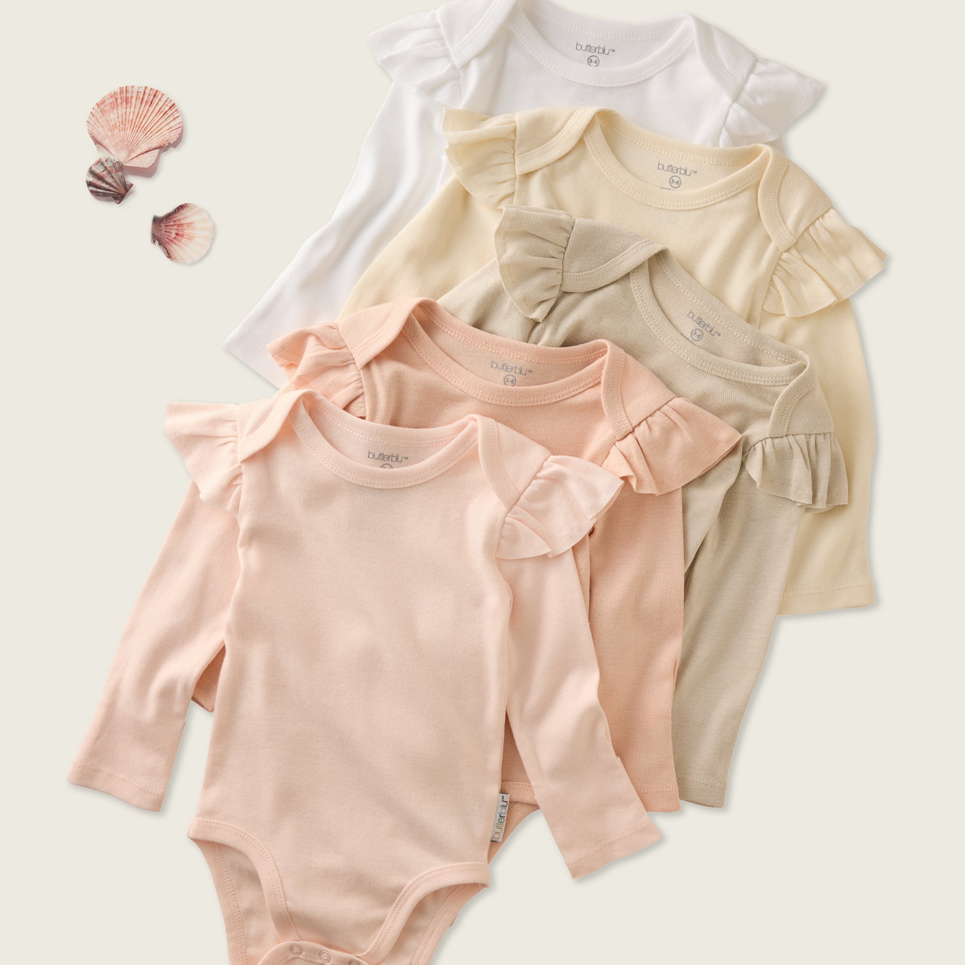 Stack of Pink Sunrise organic cotton baby bodysuits — Butterblu Ashley 5-pack layette for newborn baby girls