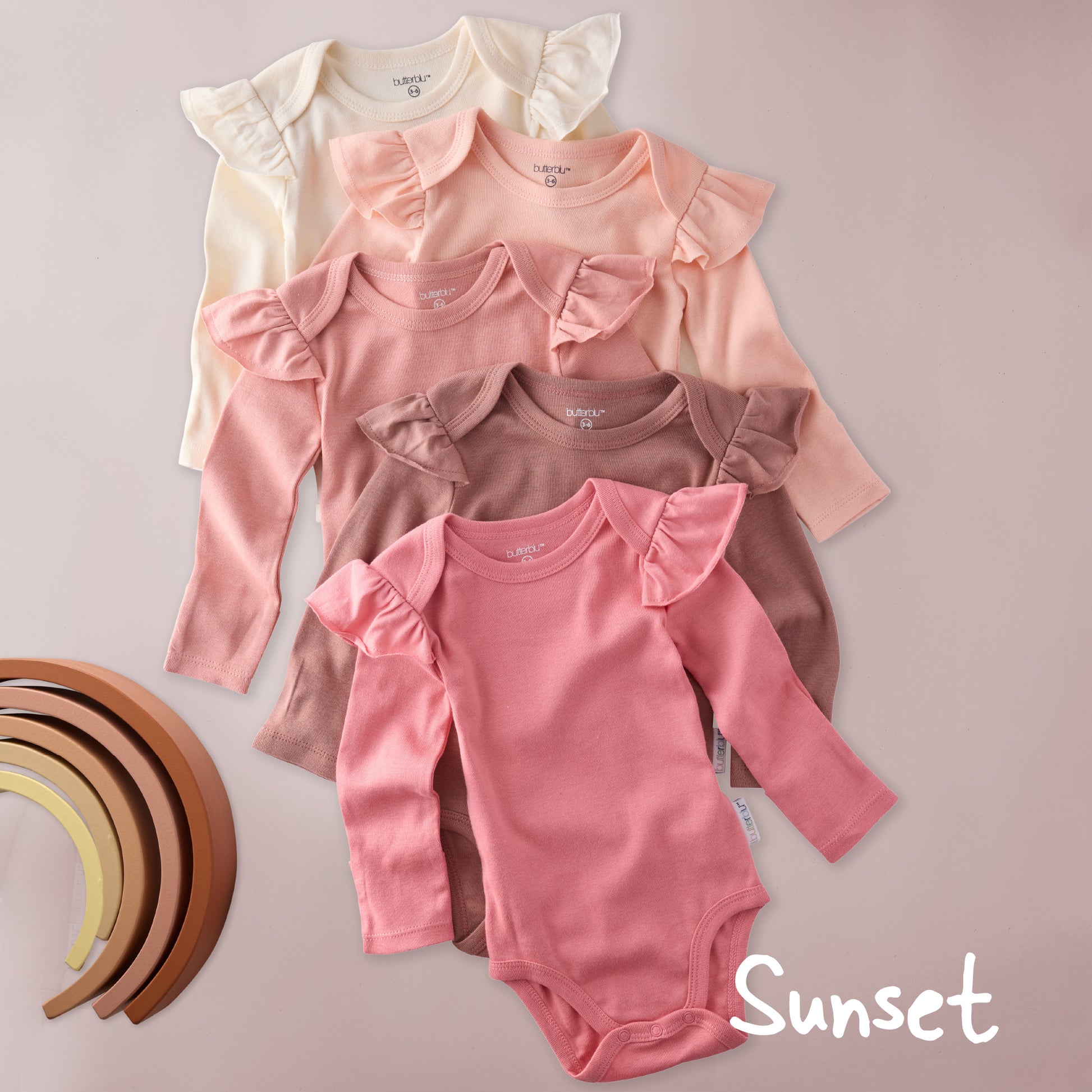 Set of baby bodysuits in various pink shades on a light background with 'Sunset' text.