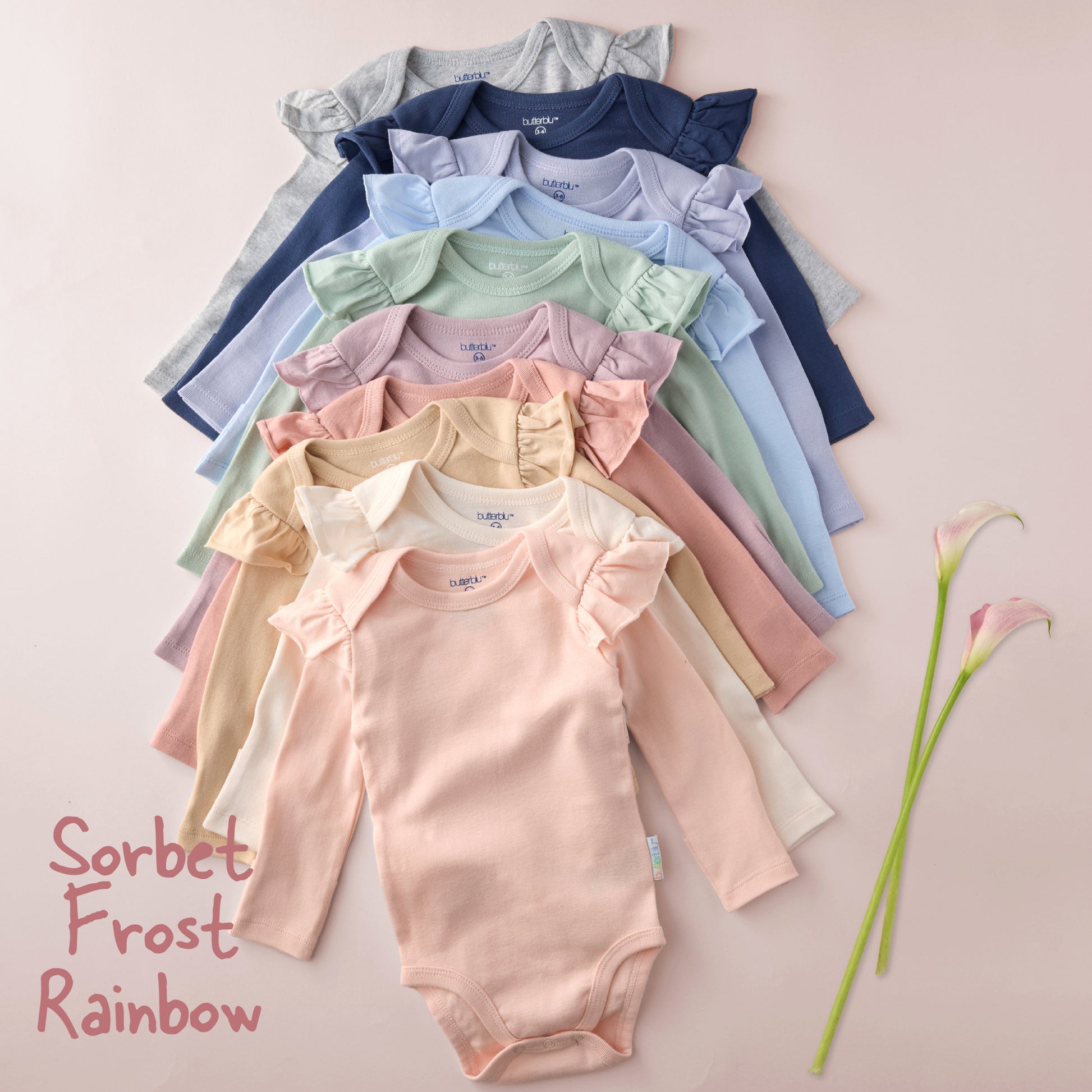 Stack of colorful baby rompers on a light background with 'Sorbet Frost Rainbow' text.