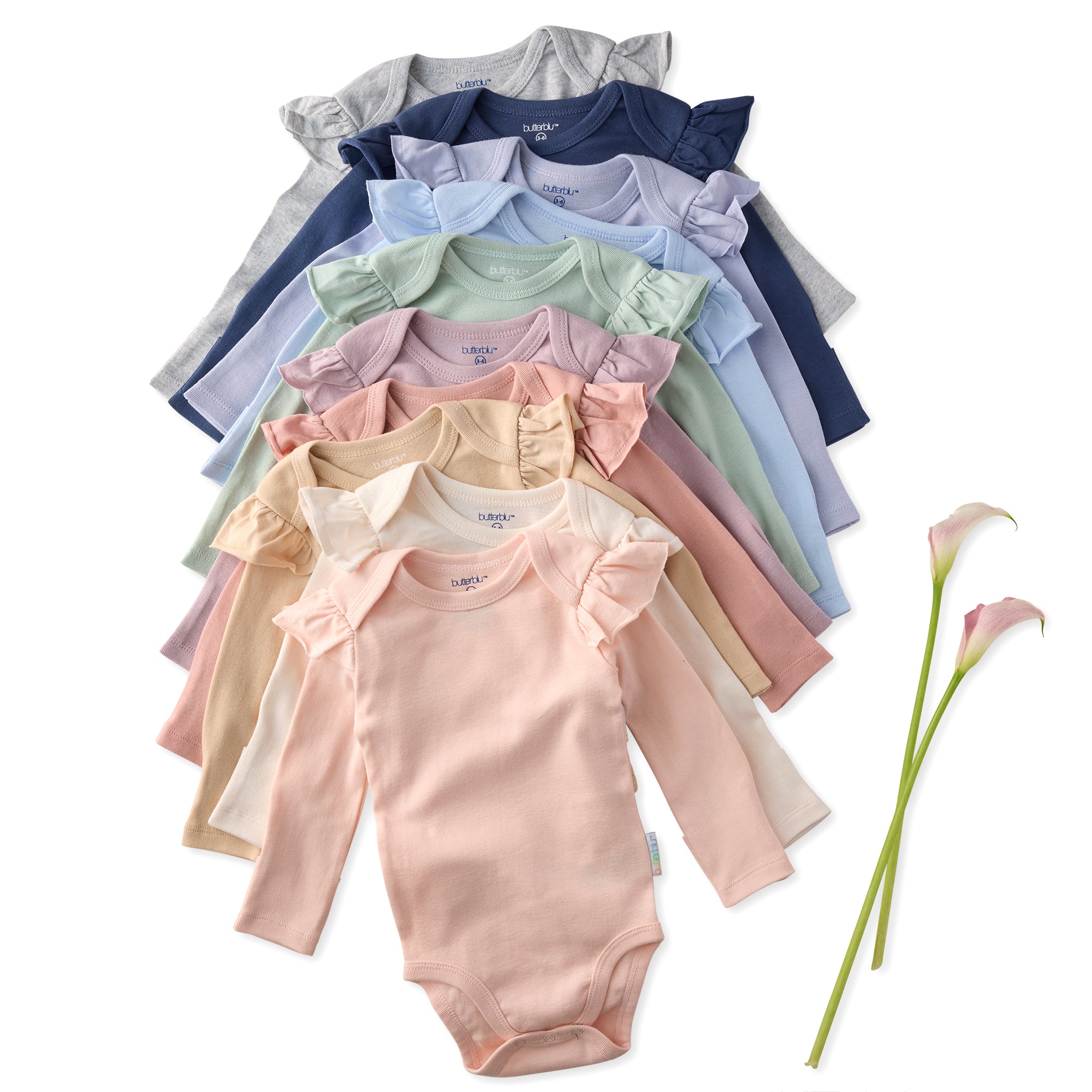 Stack of colorful baby bodysuits with a single pink calla lily on a white background