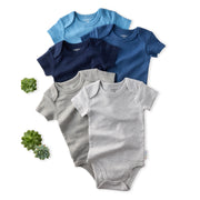 Set of baby bodysuits in blue, gray, and navy on a white background with small plants.