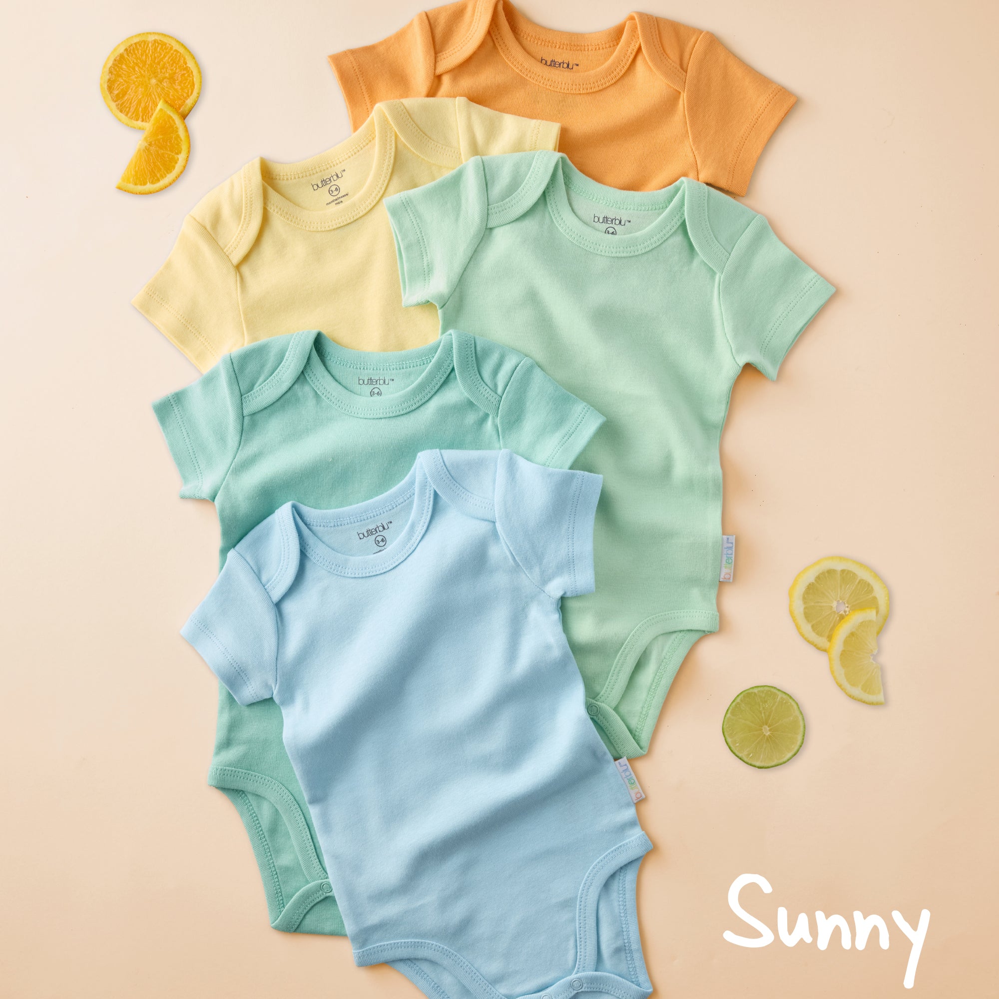 Set of colorful baby bodysuits on a beige background with 'Sunny' branding.
