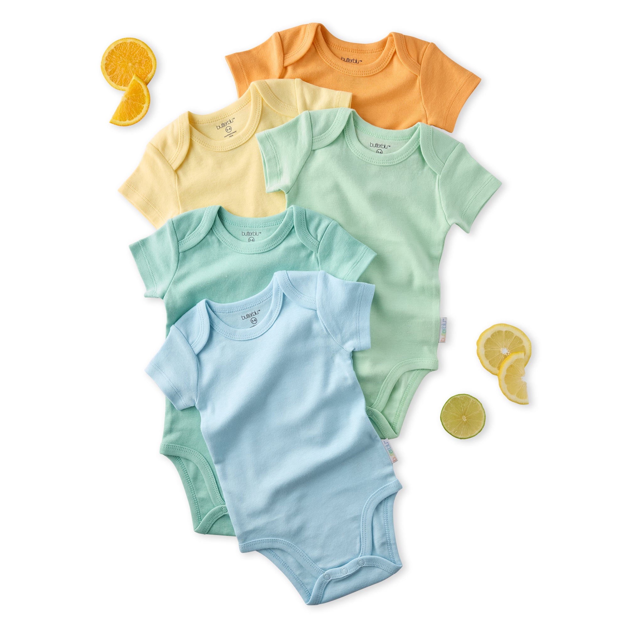 Set of five colorful baby bodysuits on a white background with orange and lemon slices.