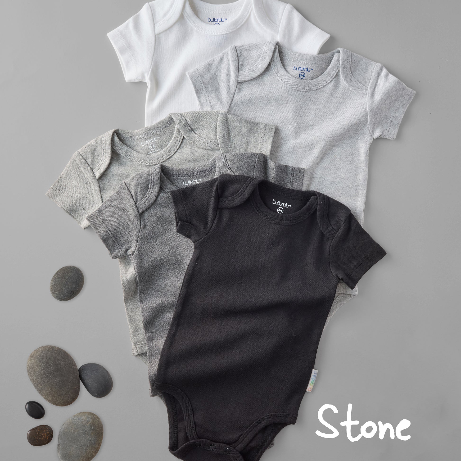 Four baby bodysuits in gray and black on a gray background with 'Stone' text.