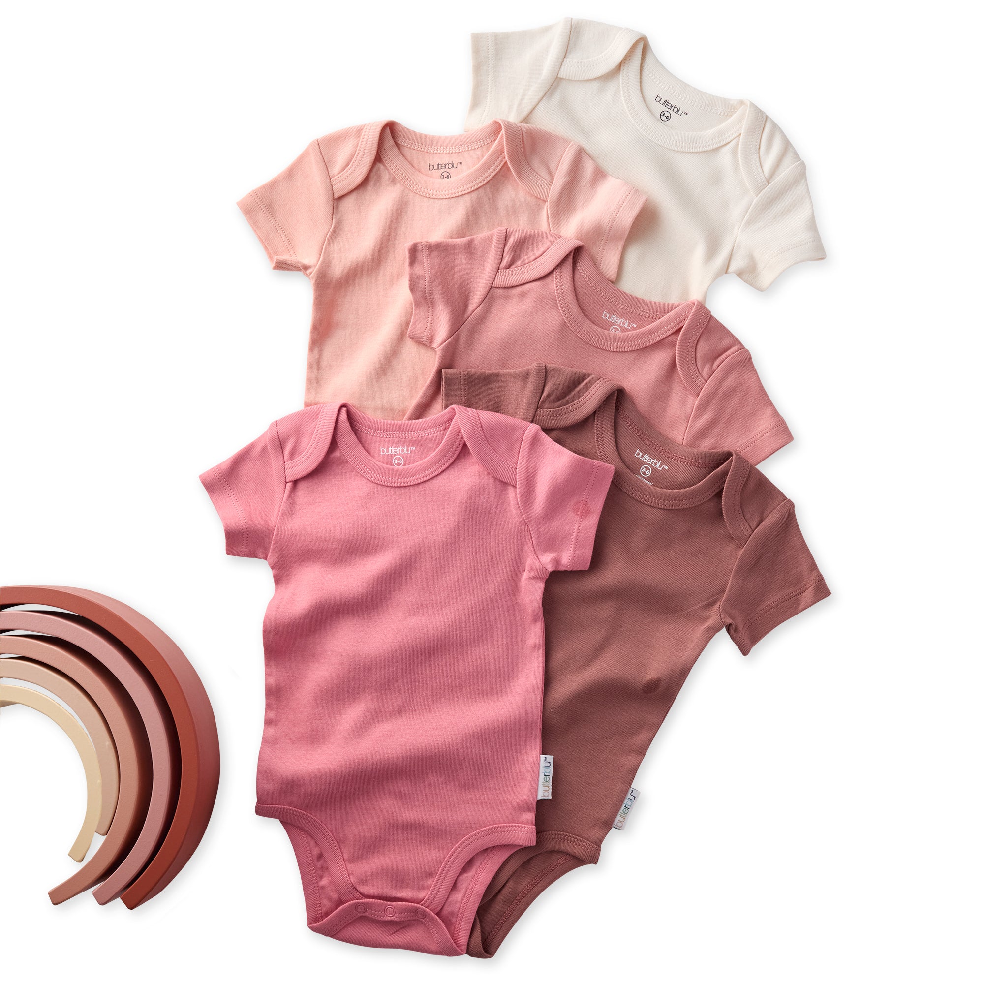 Set of baby bodysuits in various shades on a white background