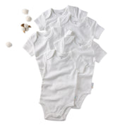 Set of white baby bodysuits on a white background
