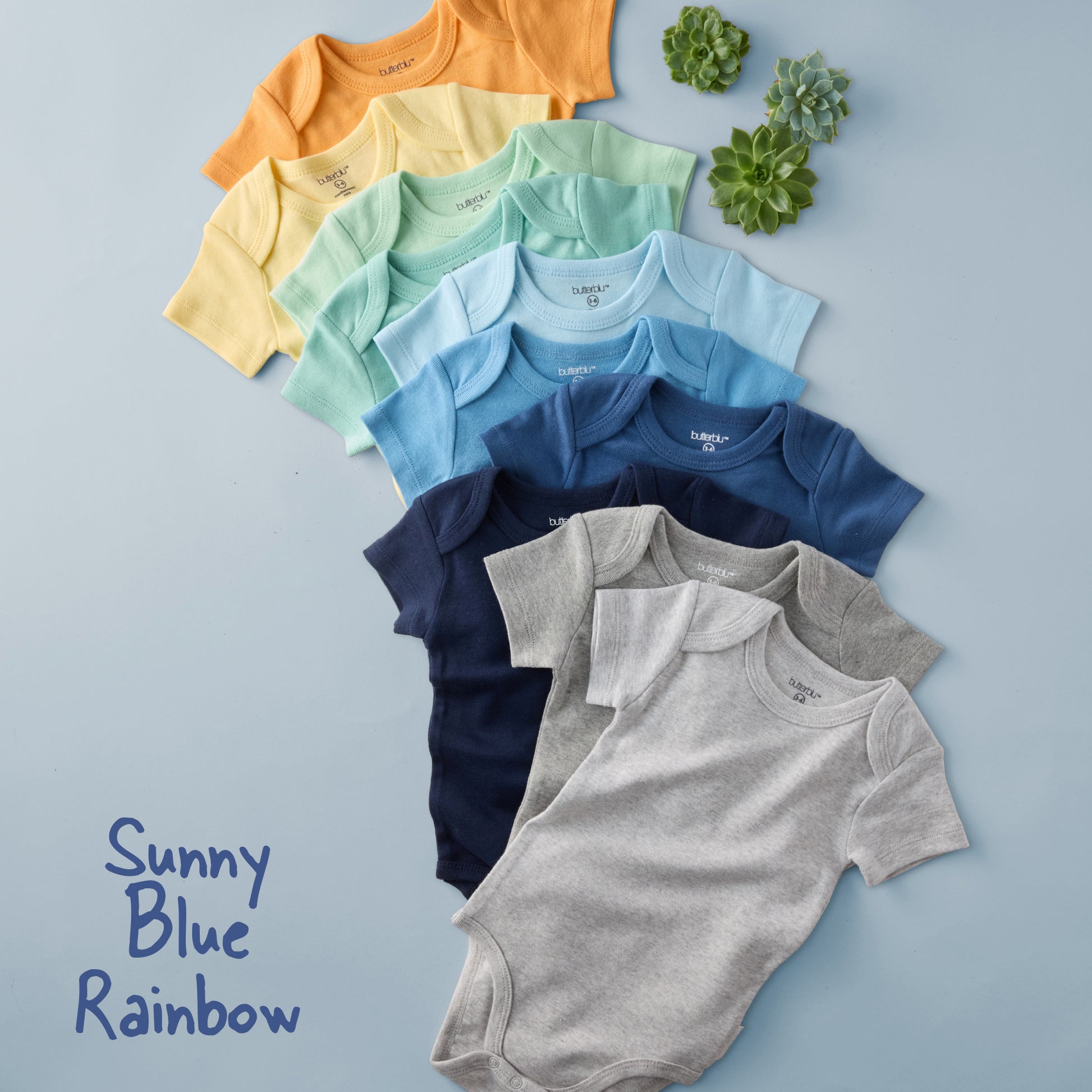 Row of colorful baby bodysuits on a light blue background with 'Sunny Blue Rainbow' text.
