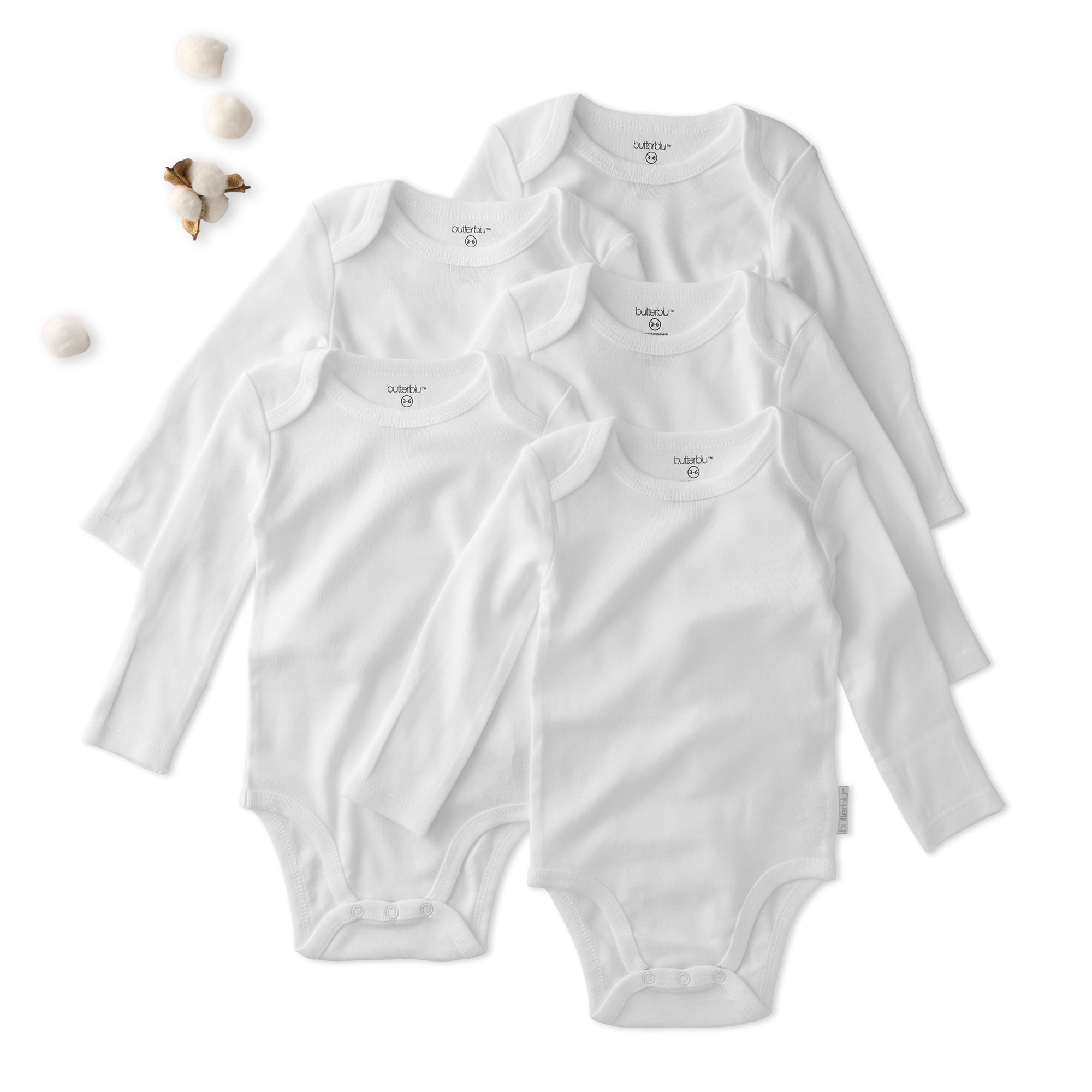 Five white baby bodysuits stacked on a white background