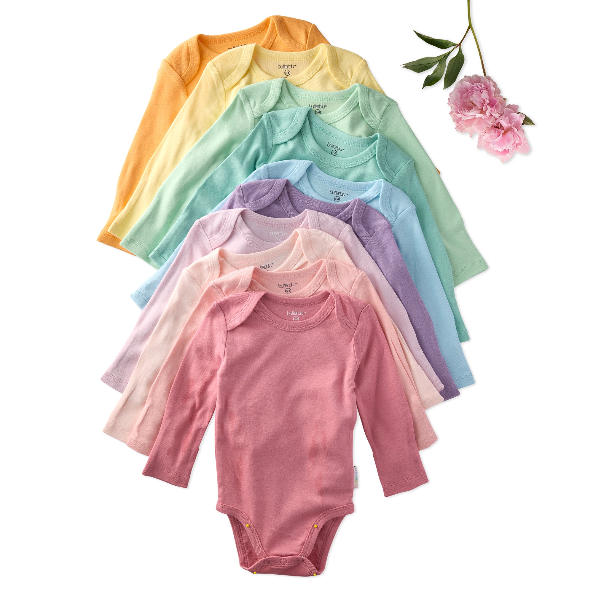 Bodysuits in rainbow color options on a white background with a flower.