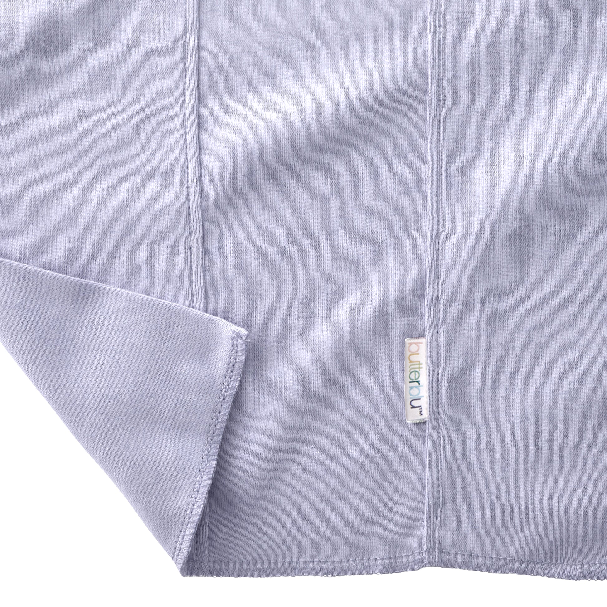 Close-up of a gray fabric with a brand tag on a white background