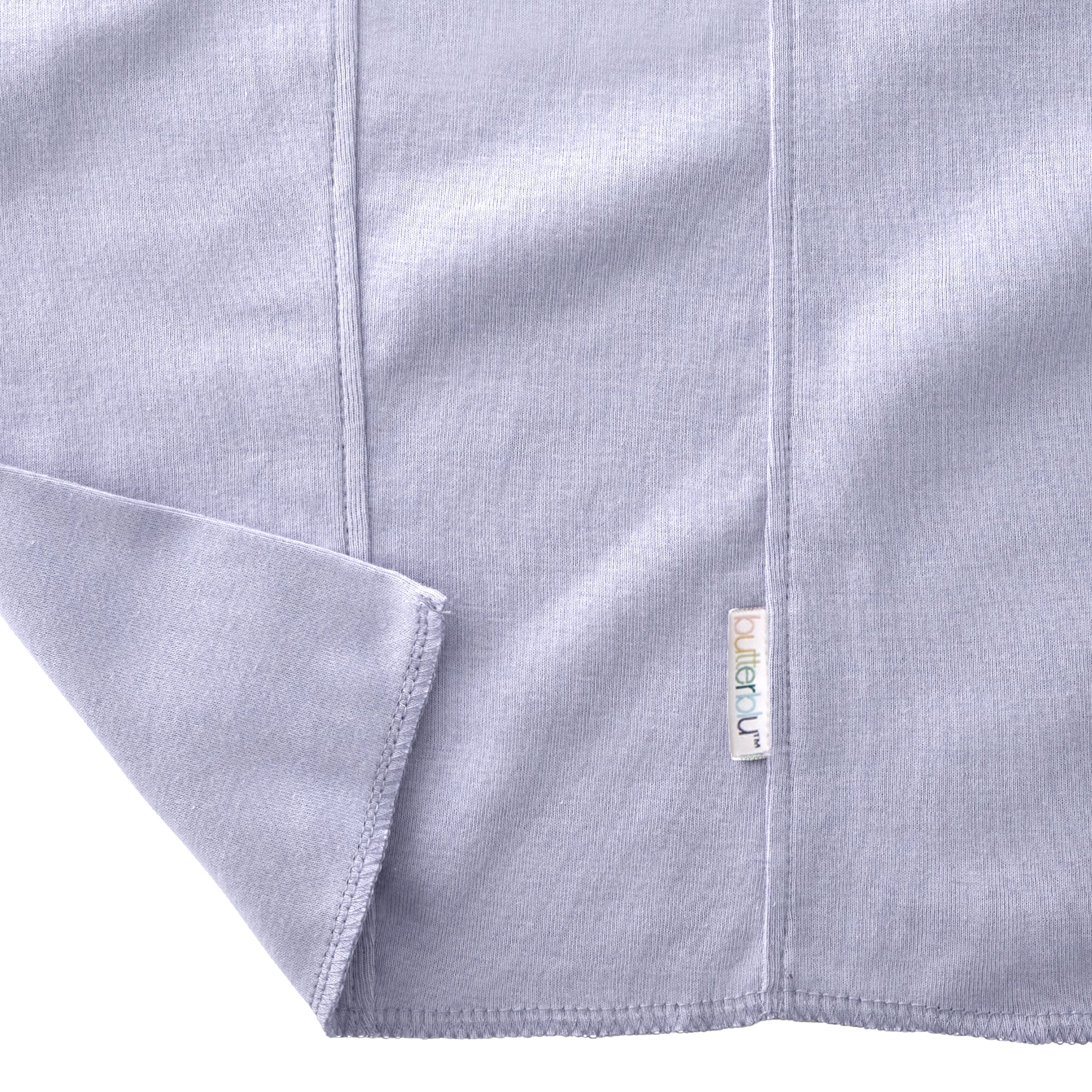 Close-up of a gray fabric with a brand tag on a white background