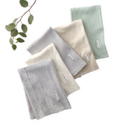 Set of folded BAILEY Burp Cloths in gray, beige, and green on a white background with a branch of leaves.