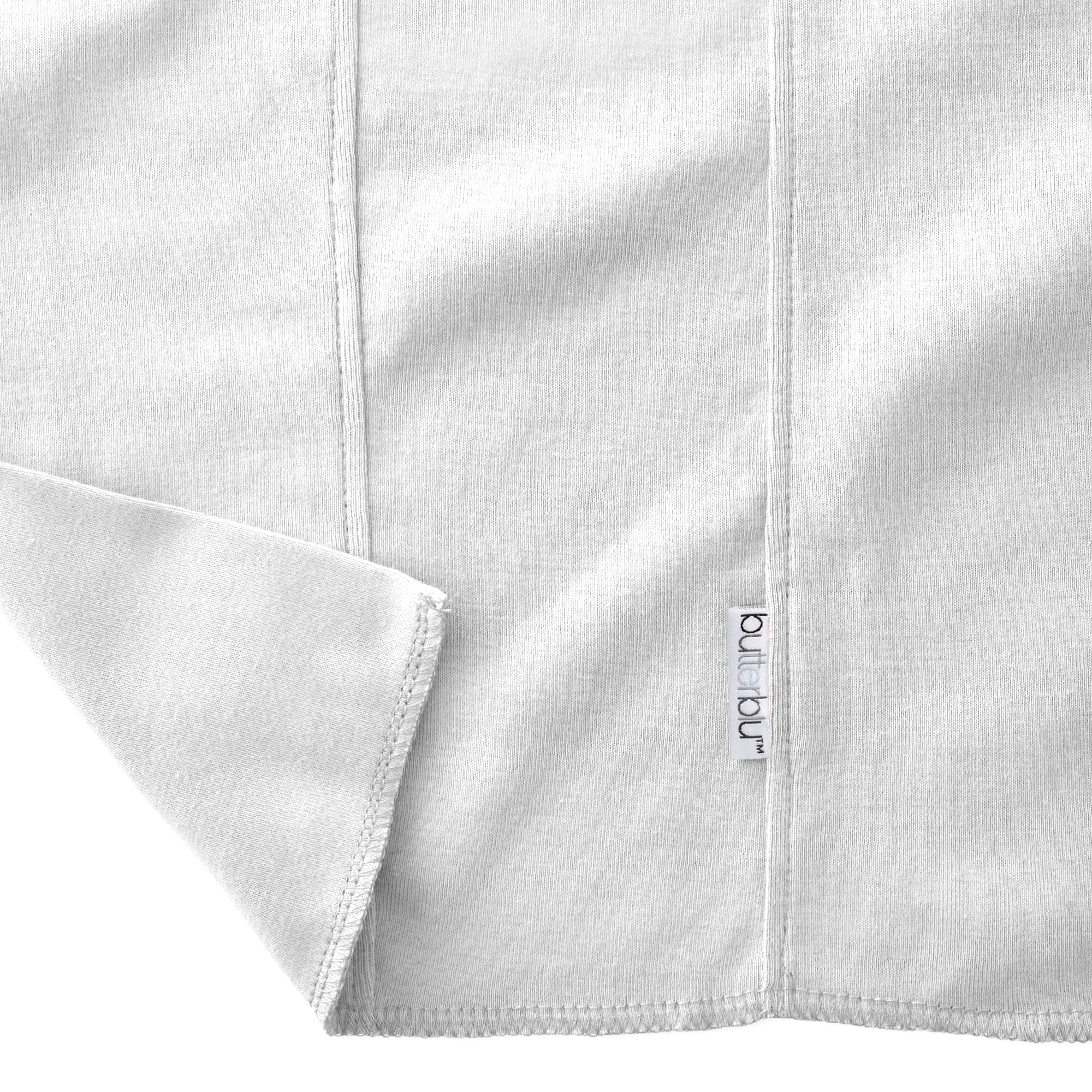 Close-up of a folded gray fabric with a brand label on a white background