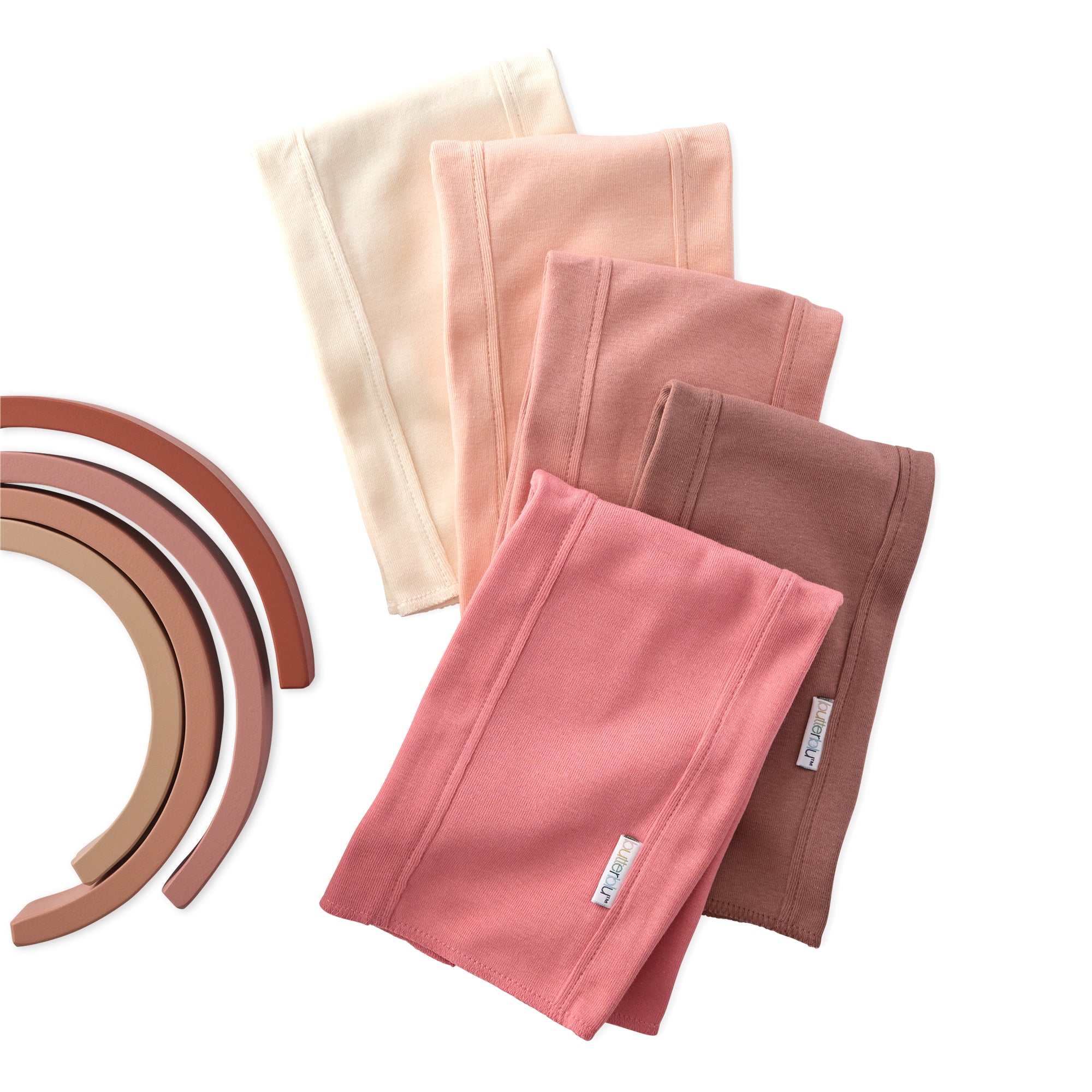 Set of folded fabric panels in various colors with wooden rings on a white background
