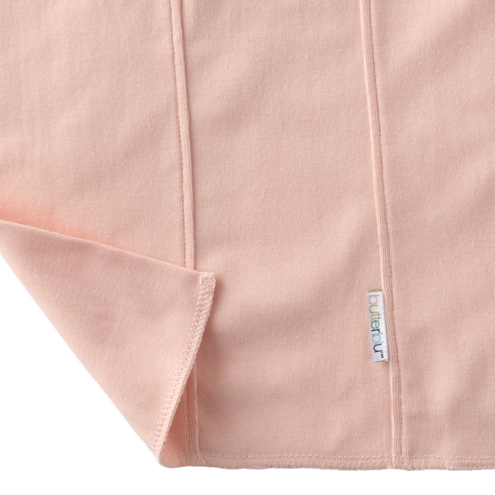 Close-up of a pink fabric with a brand label on a white background