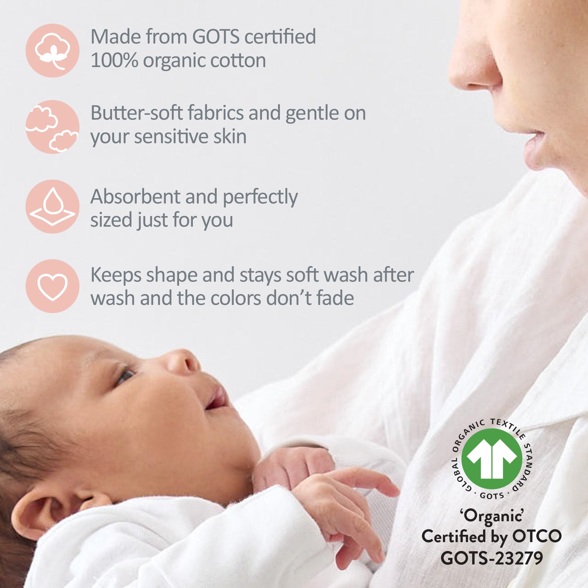 Baby wrapped in white fabric with GOTS certification logo and text about organic cotton.