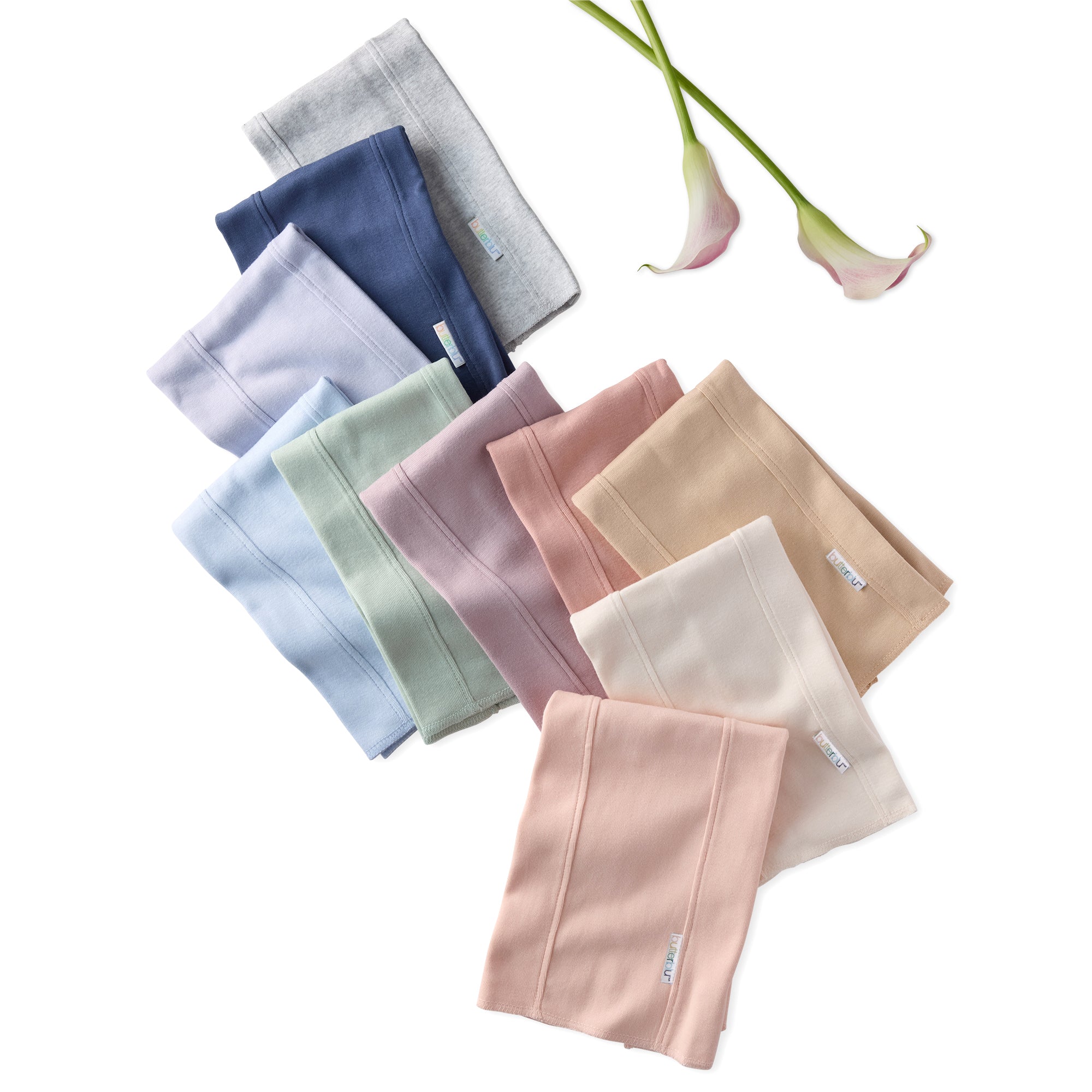 Set of folded fabric pieces in various colors on a white background with flowers.