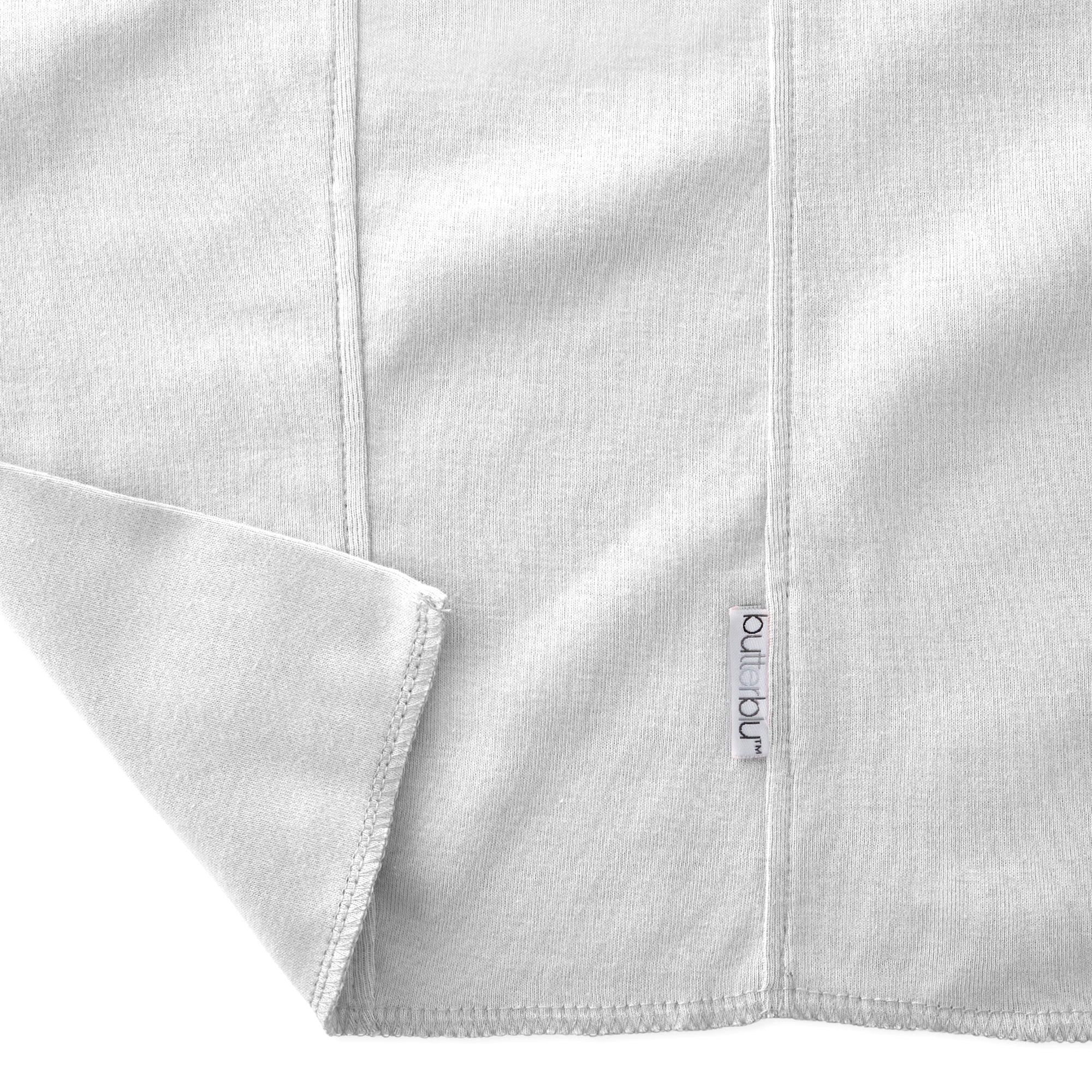 Close-up of a folded gray fabric with a brand label on a white background