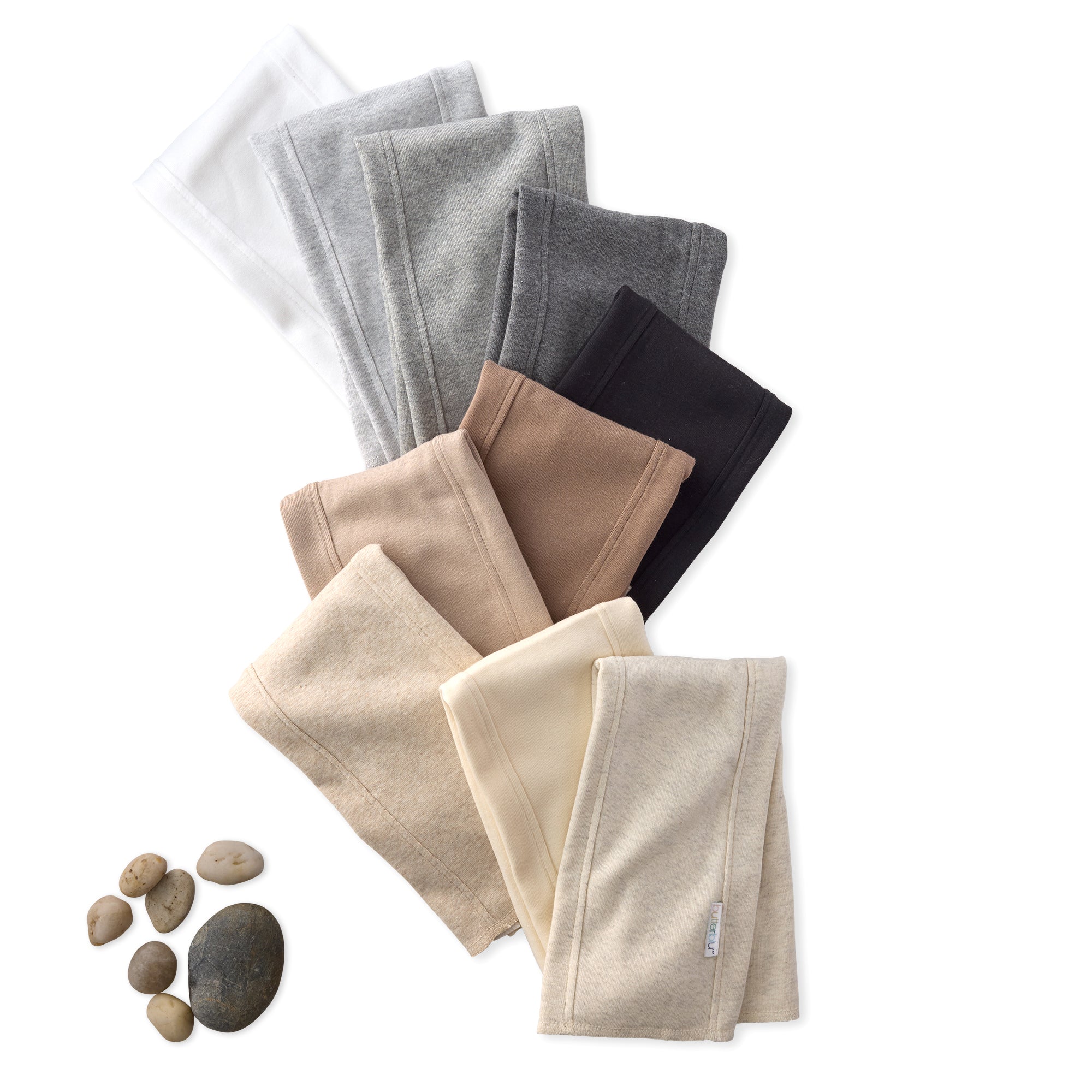 Set of folded fabric samples in various colors on a white background with small stones.