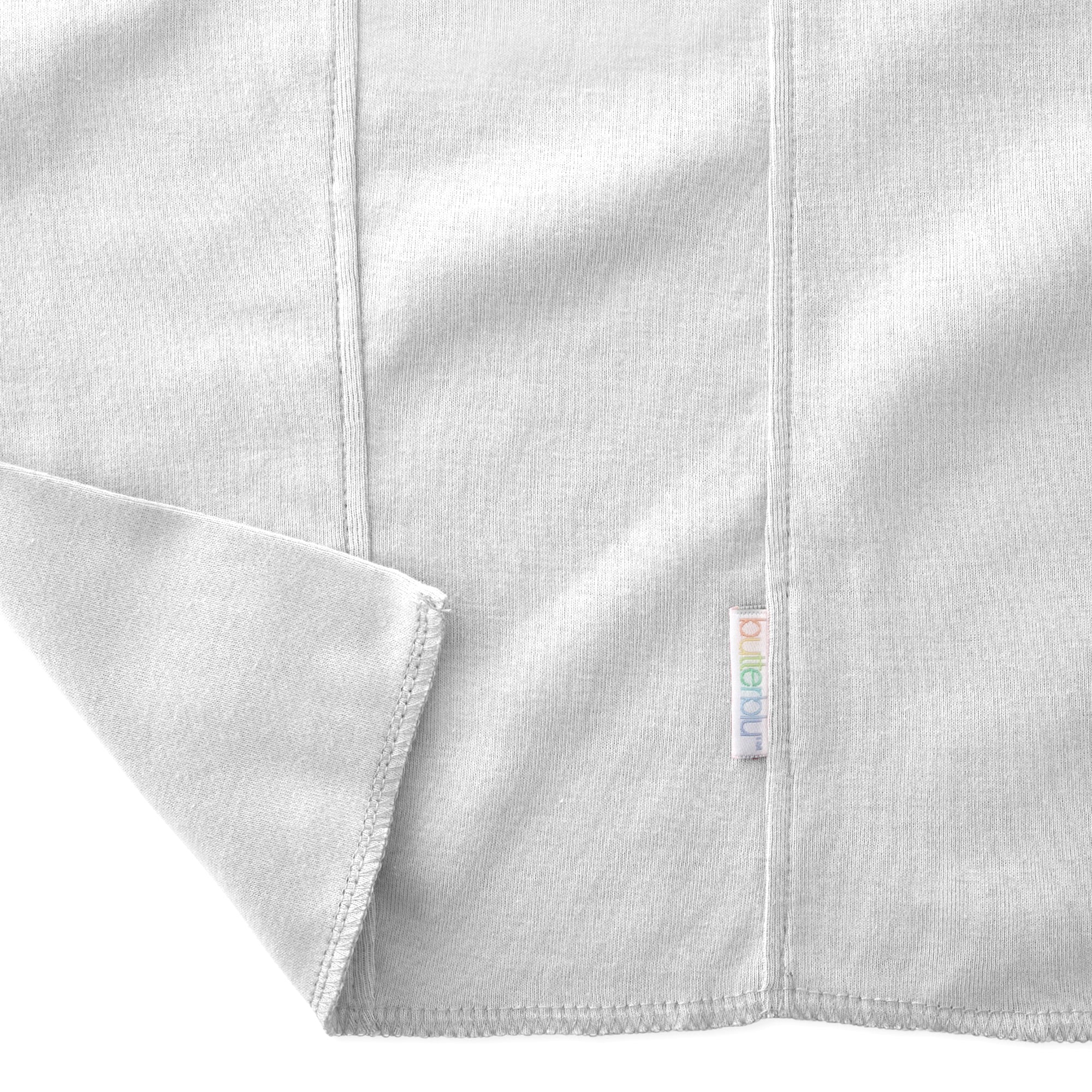 Close-up of a folded gray fabric with a brand label on a white background