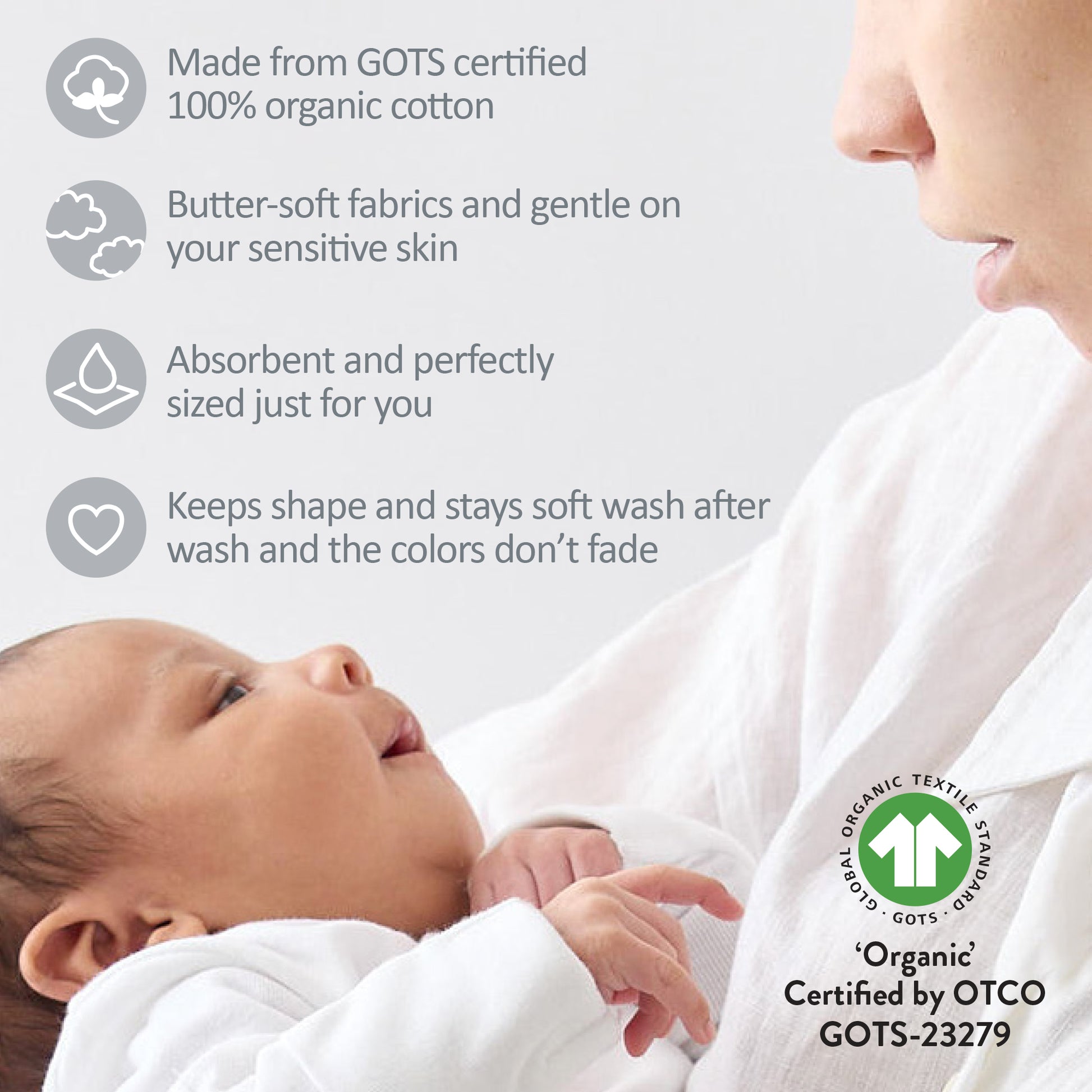 Baby wrapped in organic cotton fabric with a parent, featuring GOTS certification details.