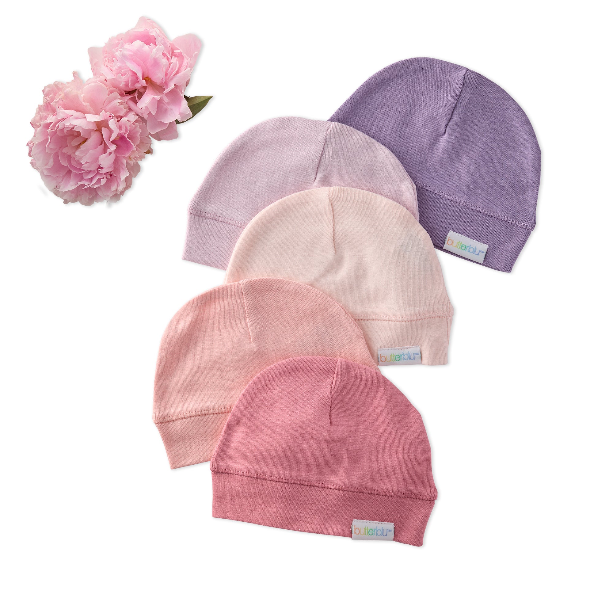Five baby hats in pink and purple on a white background with a pink flower.