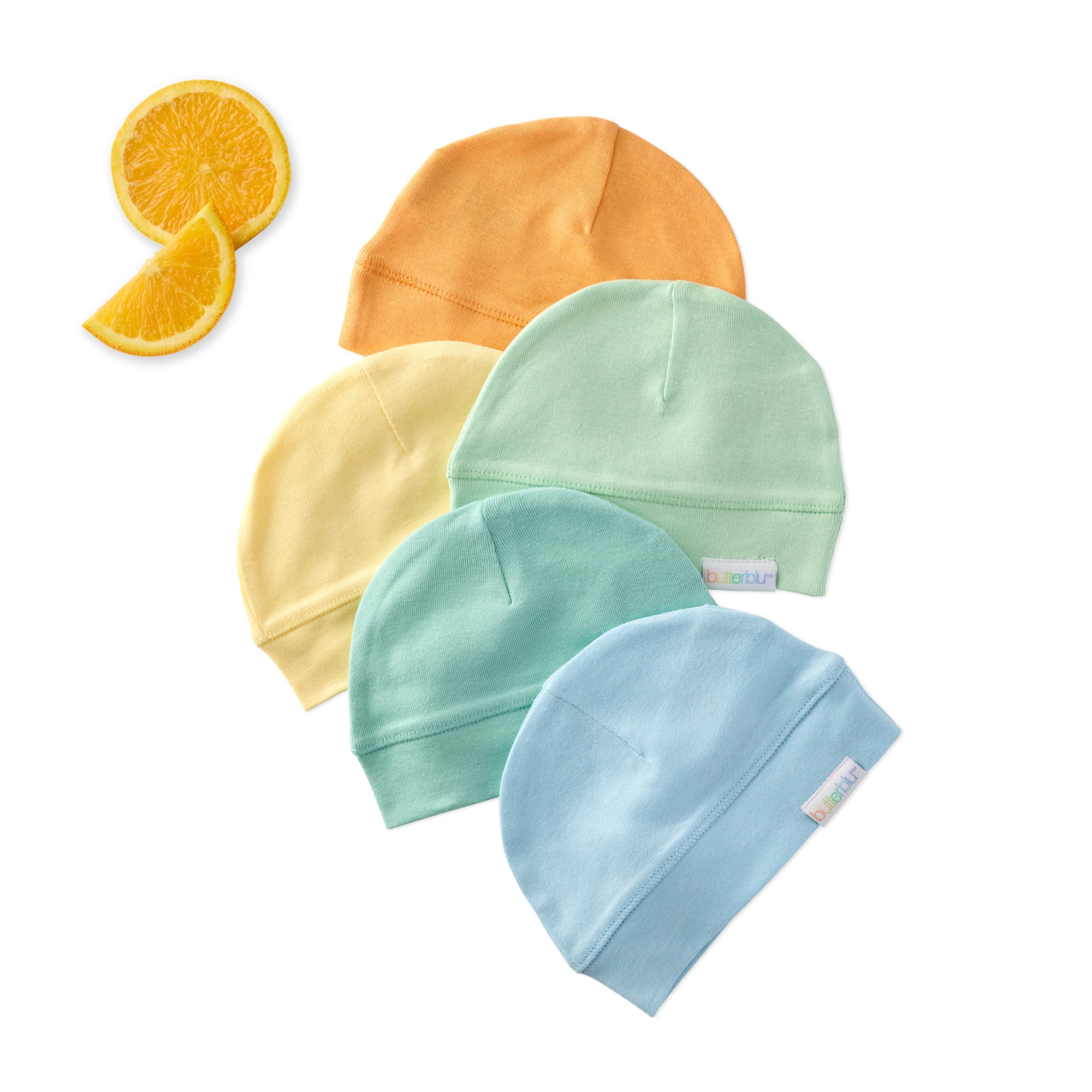 Five baby hats in orange, yellow, green, and blue with two orange slices on a white background.