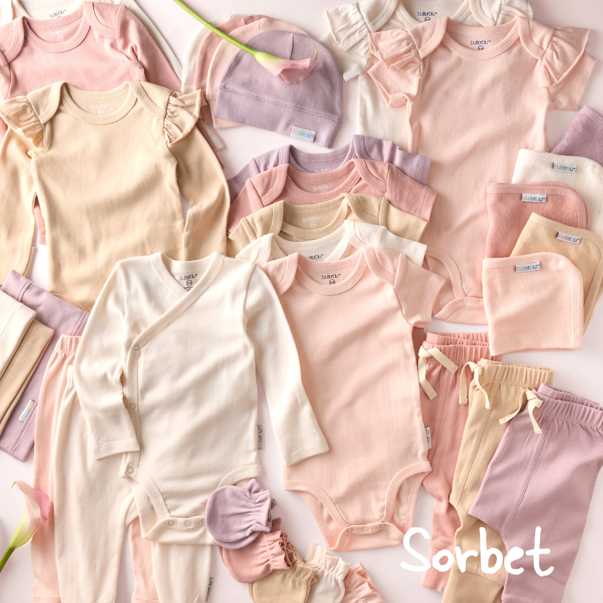 Collection of baby clothes in pastel colors with 'Sorbet' branding.