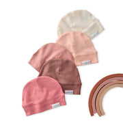 Set of baby hats in various colors on a white background