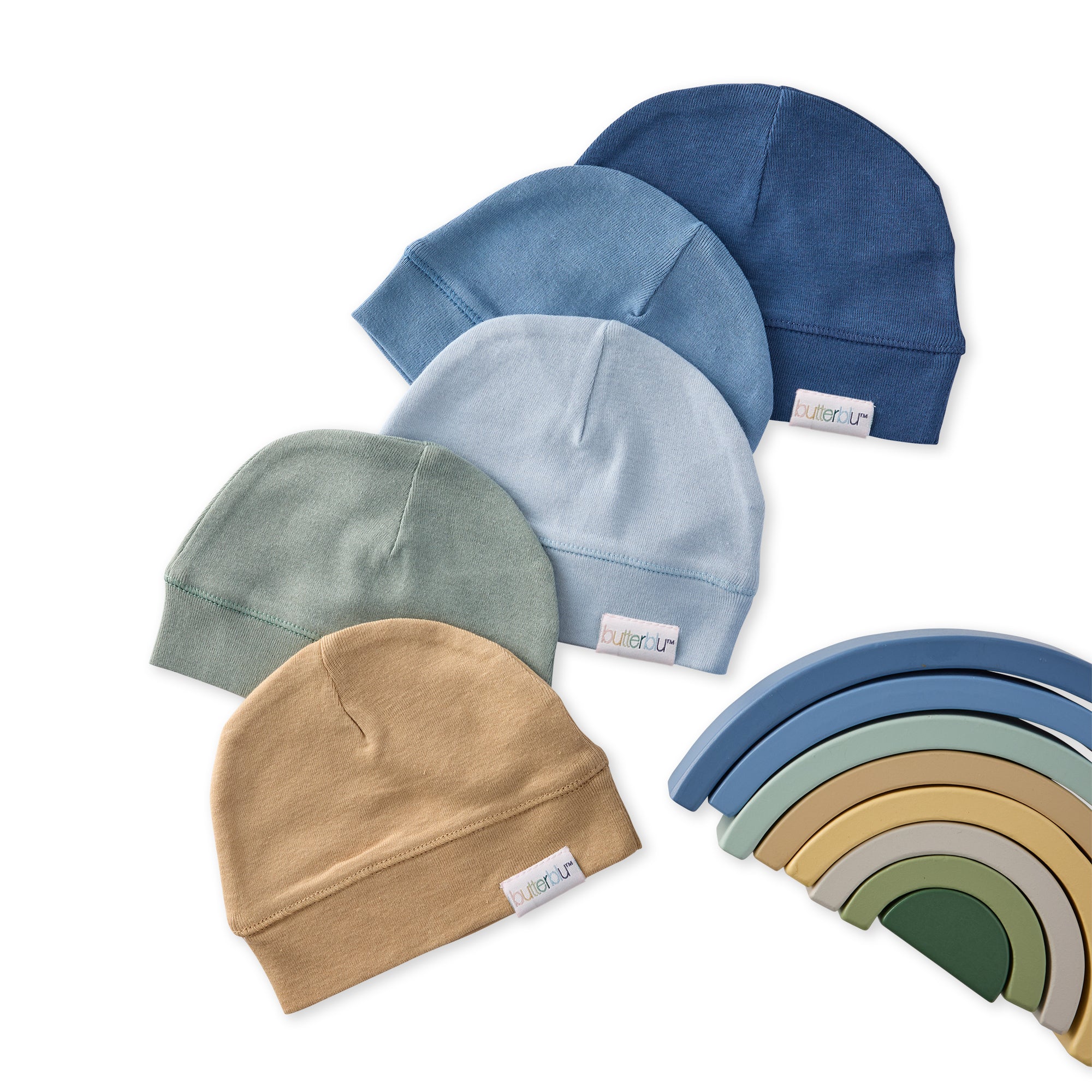 Set of five baby hats in different colors with a rainbow-shaped object in the corner.