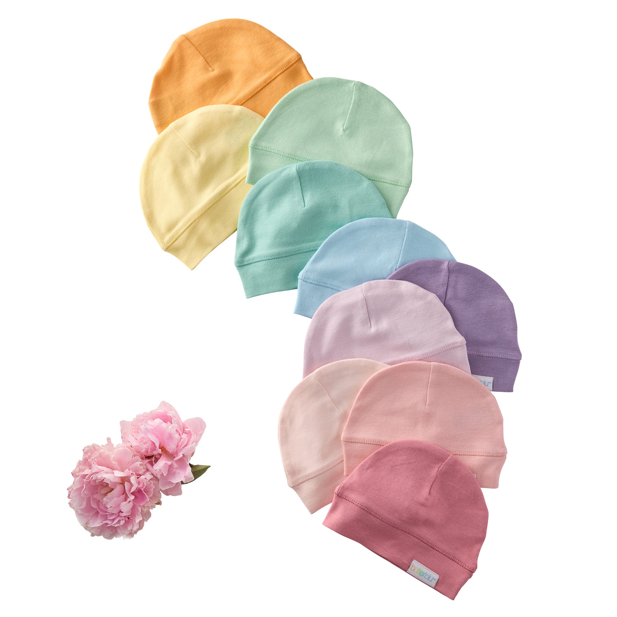 Set of colorful baby hats arranged in a circle with a pink flower on a white background