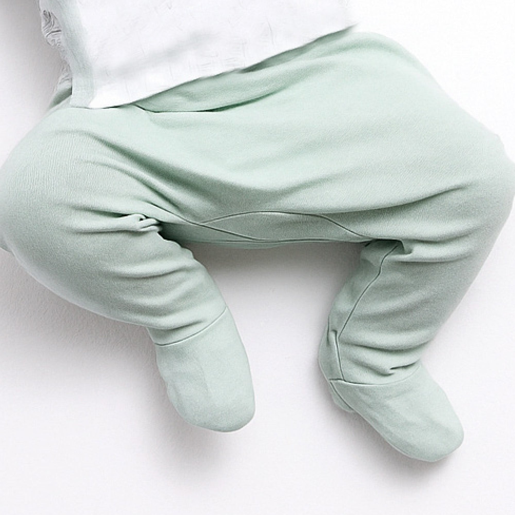Light green baby onesie on a white background