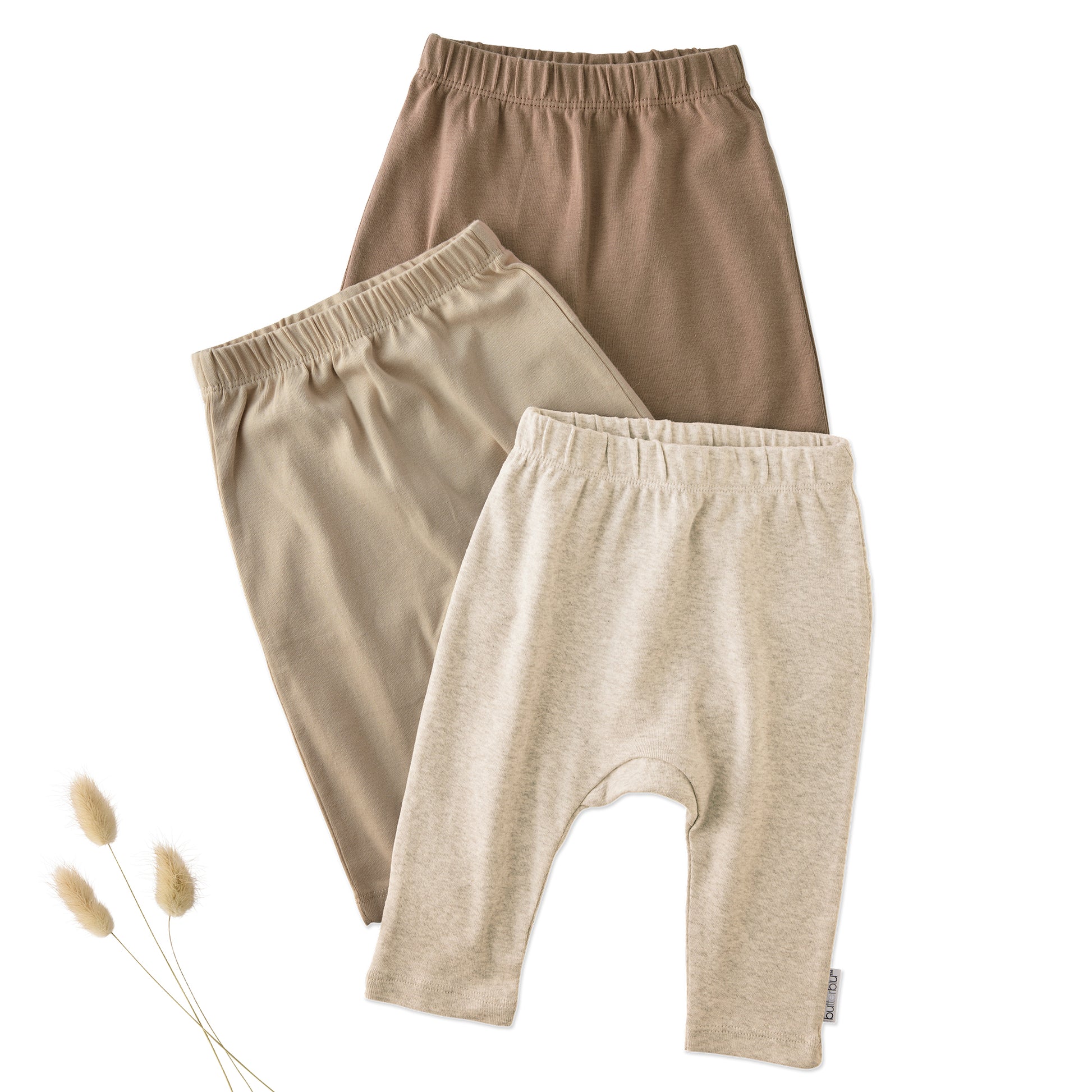 Layout of 3 pairs of harem pants in Natural on a white background with a plant detail
