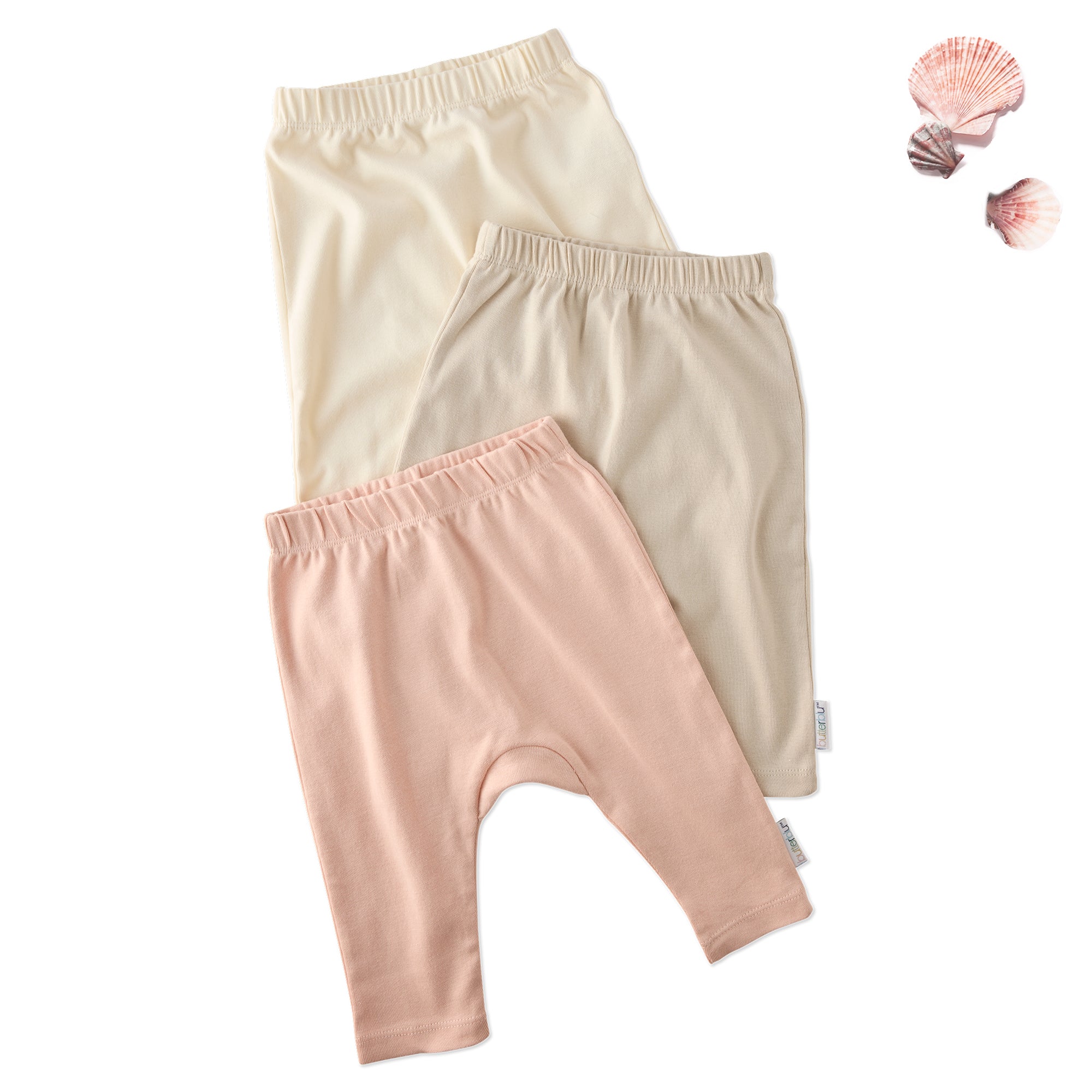 Layout of 3 pairs of harem pants in Pink Sands on a white background with a shell detail