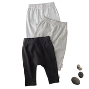 Layout of 3 pairs of harem pants in Stone on a white background with a stone detail
