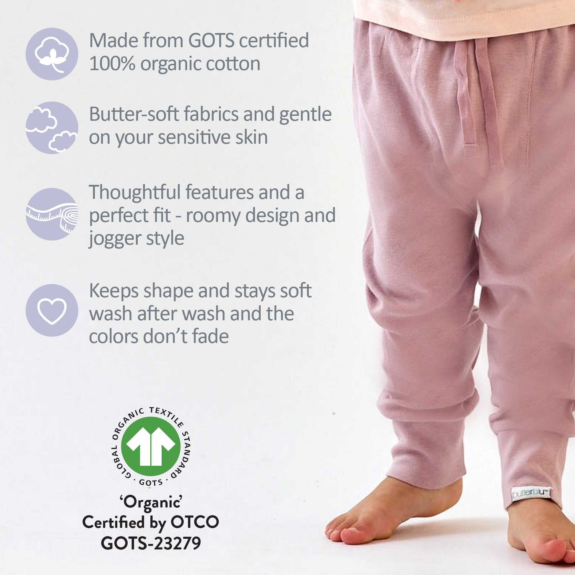 Pink pajama pants with GOTS certification details on a white background