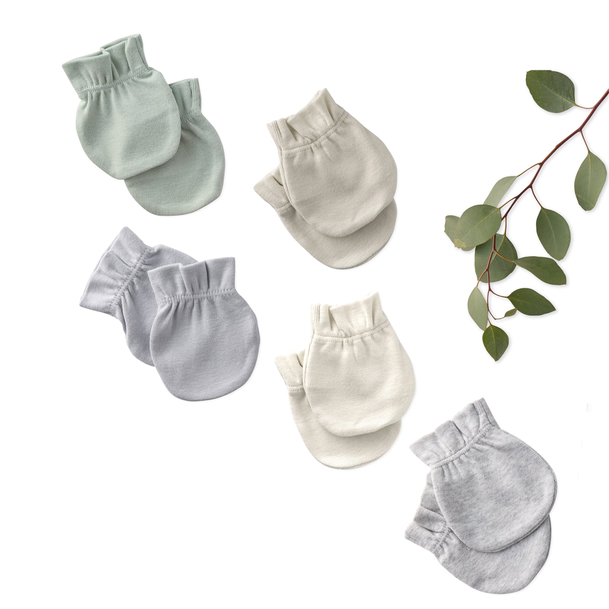 Set of baby mittens in various shades of gray on a white background with green leaves.