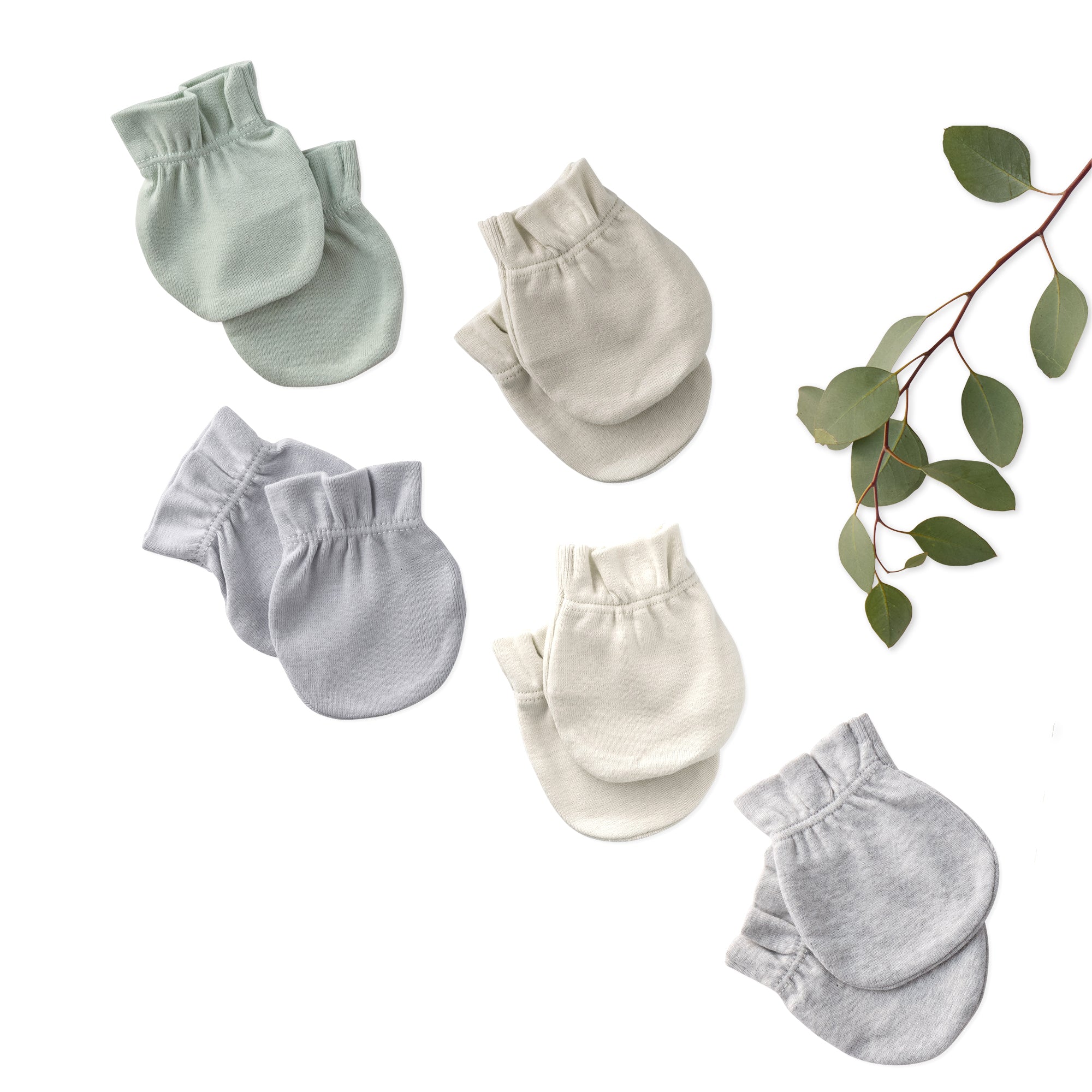 Set of baby mittens in various shades of gray on a white background with green leaves.