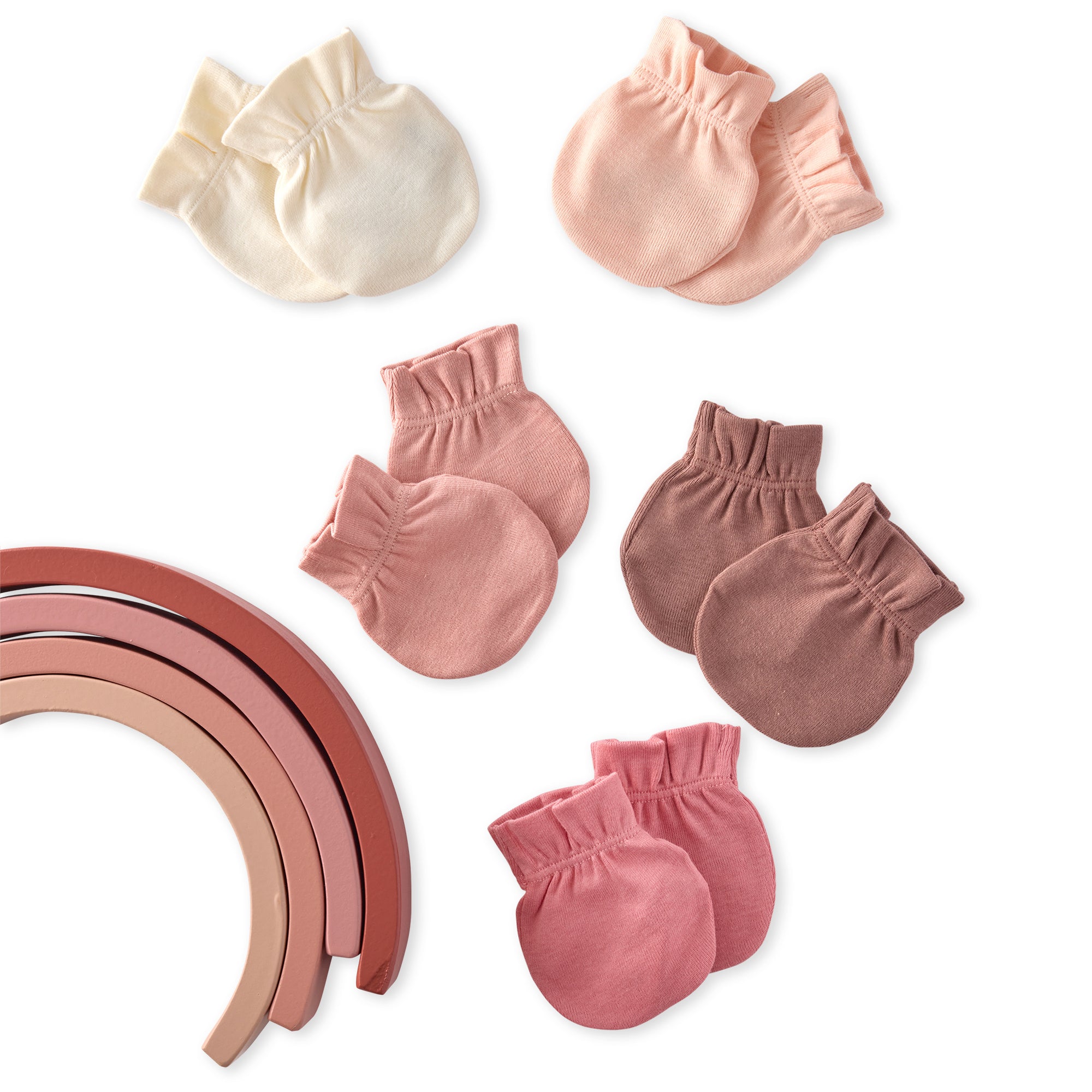 Set of baby mittens in various shades of pink on a white background