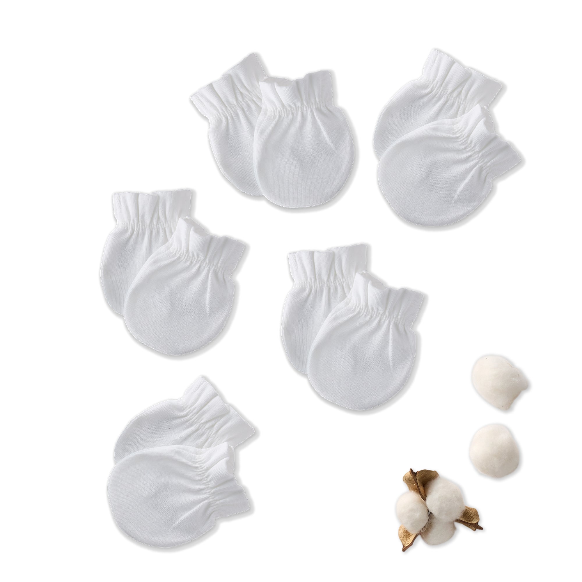 Set of white baby socks with cotton balls on a white background