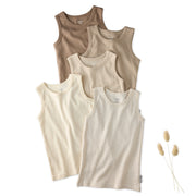 5 sleeveless shirts in Natrual on a white background with a leaf
