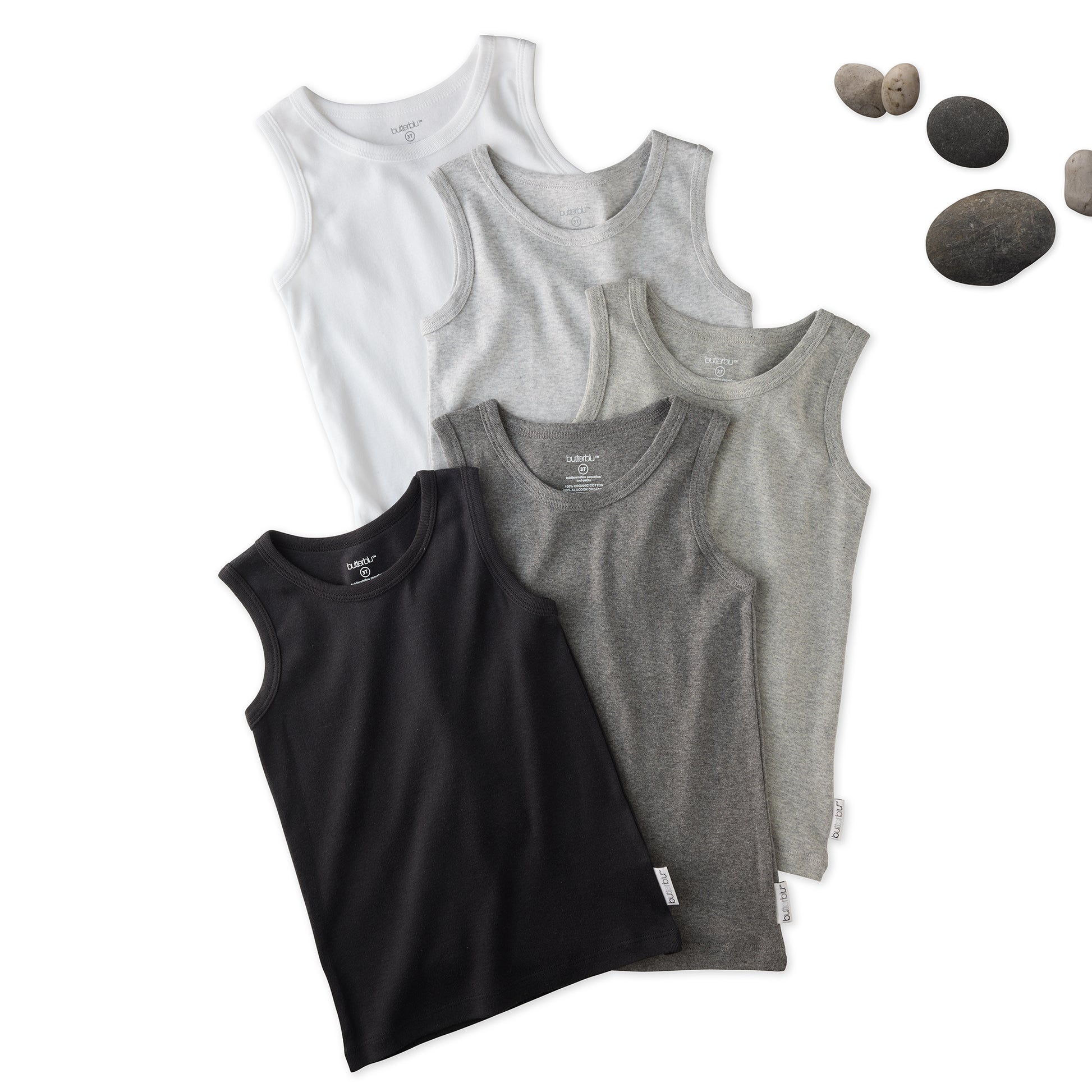 5 sleeveless shirts in Stone on a white background with stones
