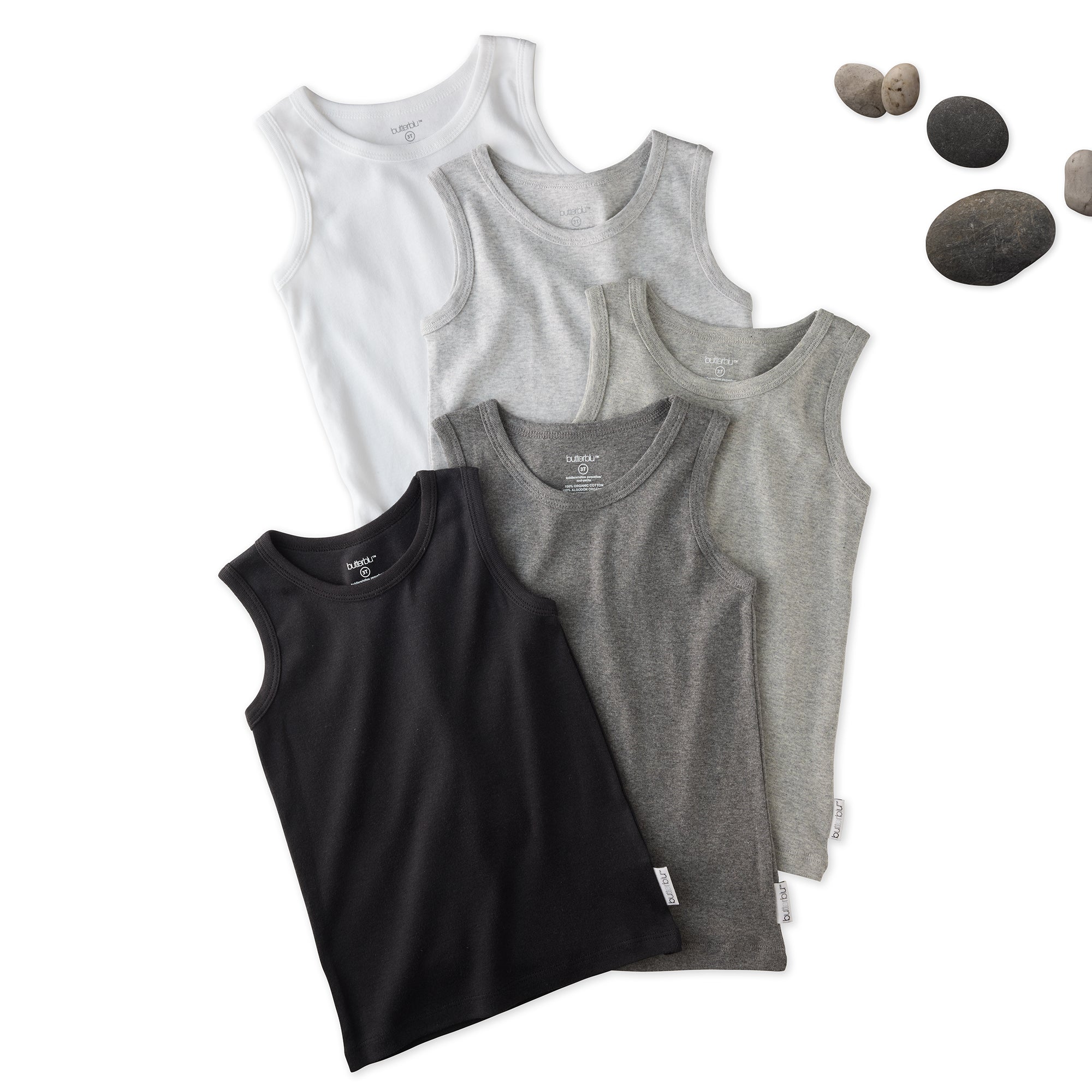 5 sleeveless shirts in Stone on a white background with stones
