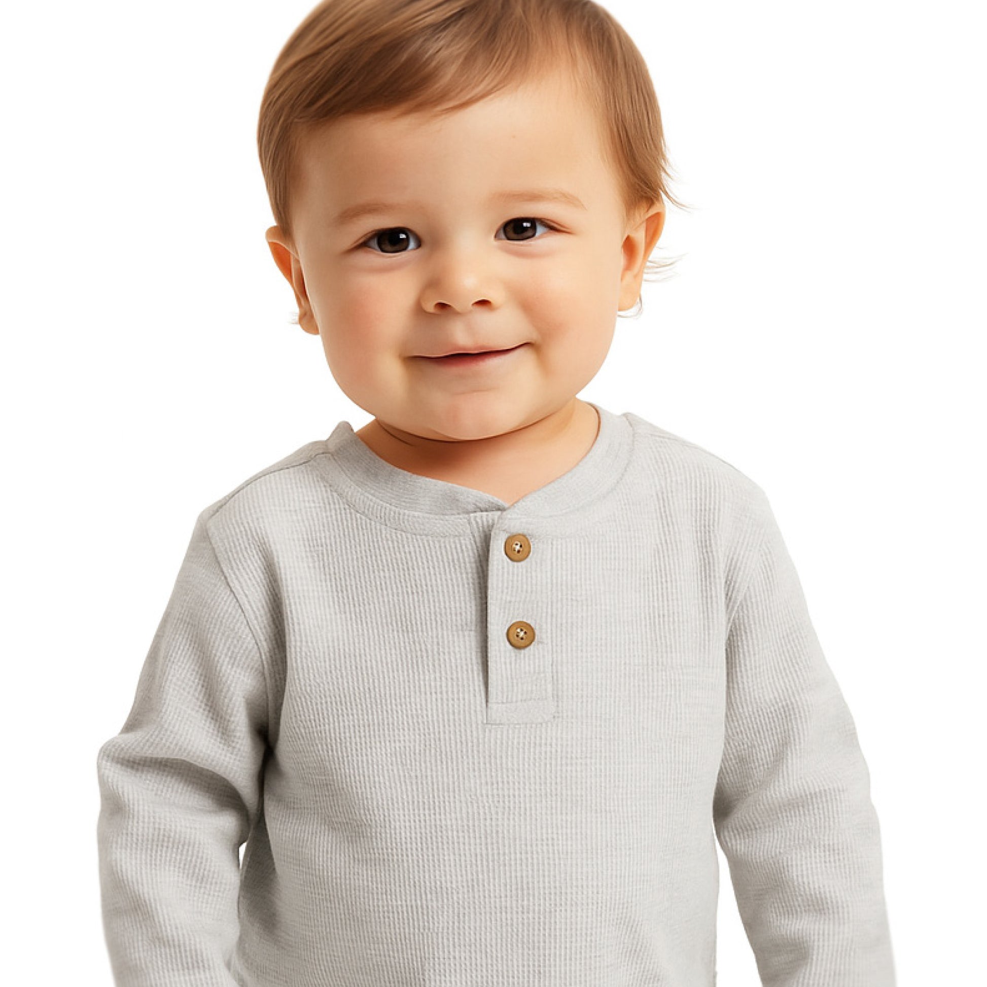 Child wearing a light gray long-sleeve shirt with brown buttons on a white background