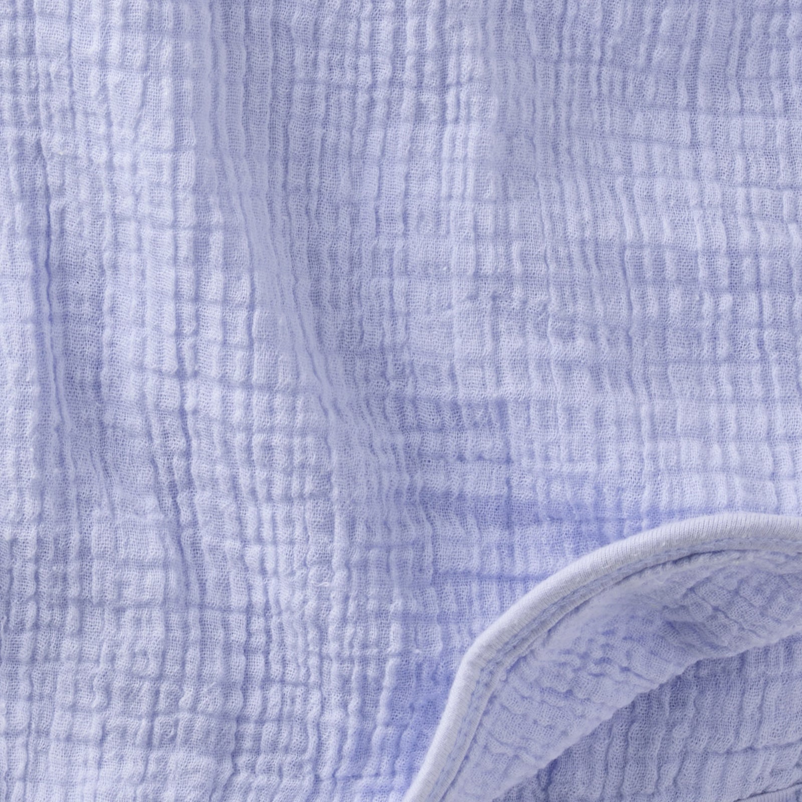 Close-up of textured blue fabric with a white border